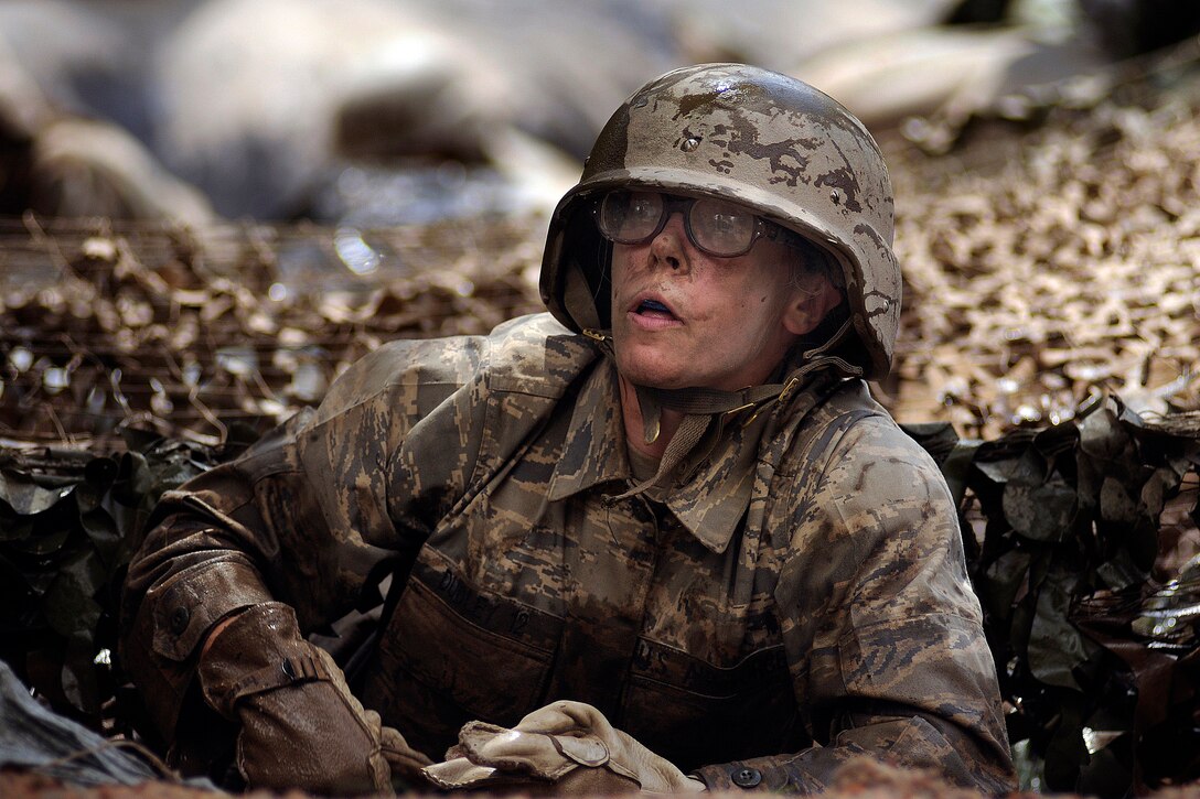 During basic cadet training, U.S. Air Force Academy Basic Cadet Jenna Dudley crawls out of a water obstacle on the assault course July 25 in the Jacks Valley training area near Colorado Springs, Colo.  (U.S. Air Force photo/Dennis Rogers)