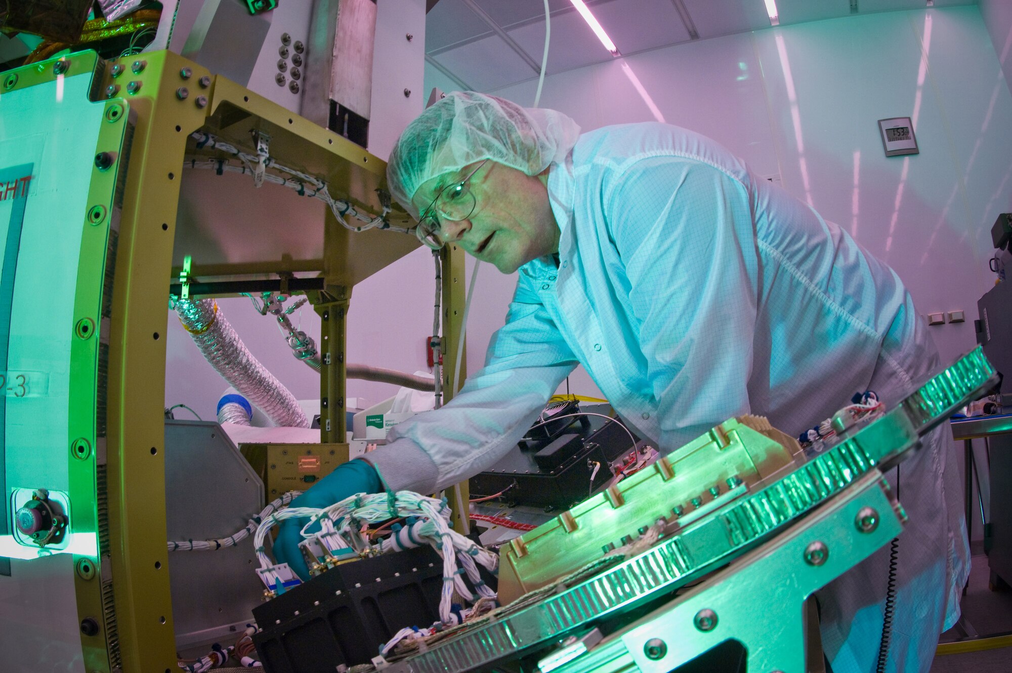 Martin Leahy performs voltage and continuity tests on a tactical satellite, known as Tactical Satellite-3, at the Space Vehicle Directorate at the Air Force Research Laboratory, Kirtland Air Force Base, N.M.  The satellite is scheduled to be launched in October. Mr. Leahy is a field engineer with ATA Aerospace.  (U.S. Air Force photo/Lance Cheung) 