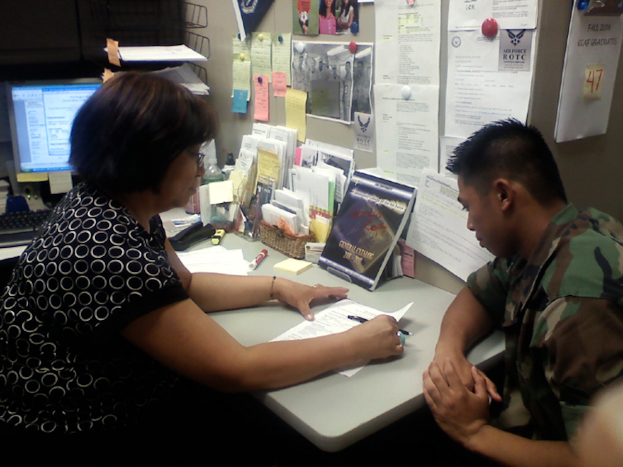 Left, Gloria Basa, 305th Mission Support Squadron Community College of the Air Force advisor, counsels Airman Mark Canto, 305th MSS customer service representative, about pursuing his CCAF degree.  The CCAF awards an associate in applied science degree after a student successfully completes a degree program in their Air Force specialty code. More than 300,000 students are registered in CCAF, and it is the only community college in the Department of Defense. (U.S. Air Force photo/Howie Mack)
