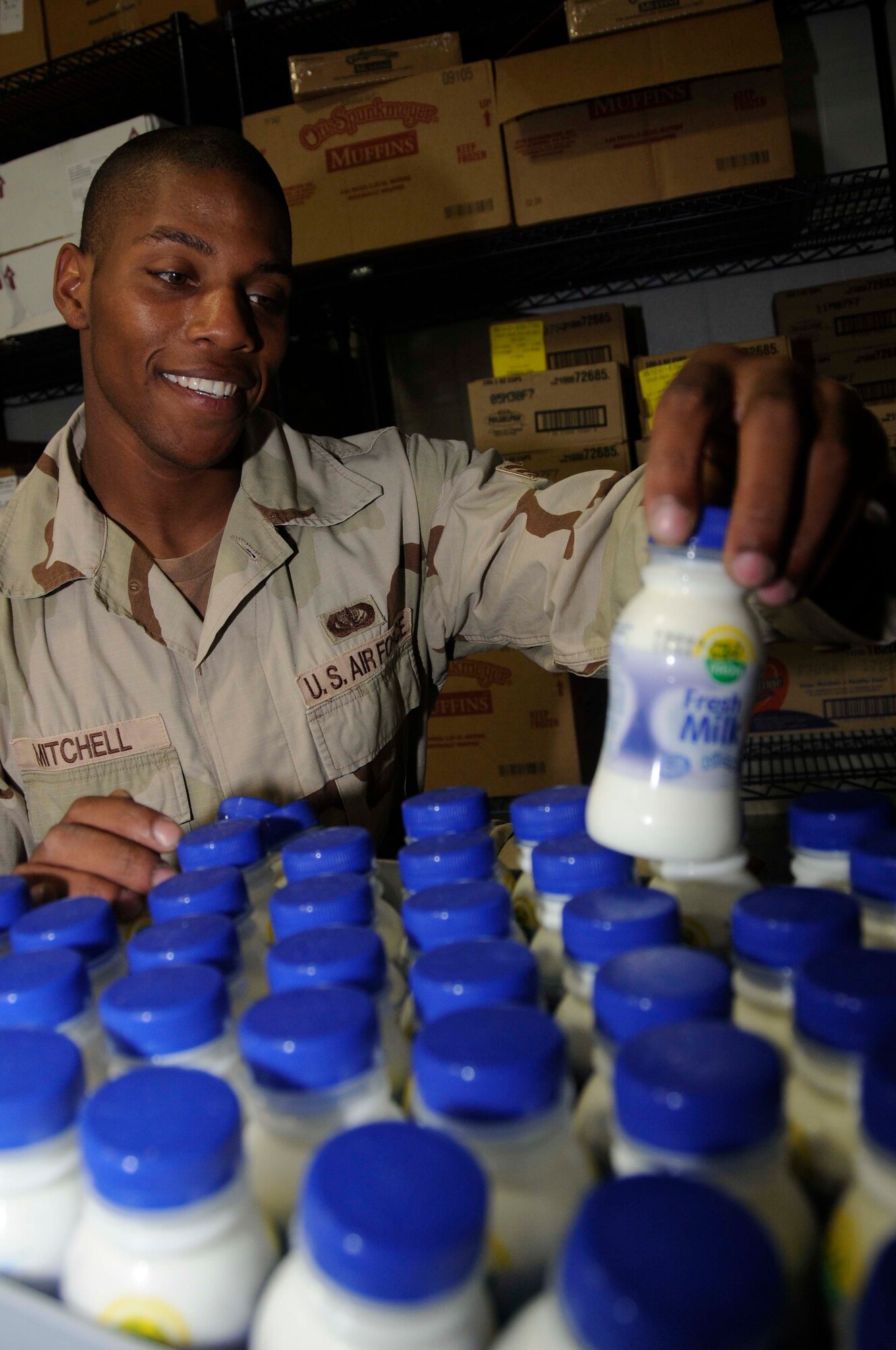 Senior Airman Adrian Mitchell, a store room clerk with the 379th Expeditionary Force Support Squadron, checks the expiration dates of milk in a dining facility Aug. 5, at an undisclosed location in Southwest Asia. Airman Mitchell, a native of Atlanta, Ga., is deployed from Ellsworth Air Force Base, S.D. (U.S. Air Force photo by Staff Sgt. Darnell T. Cannady)