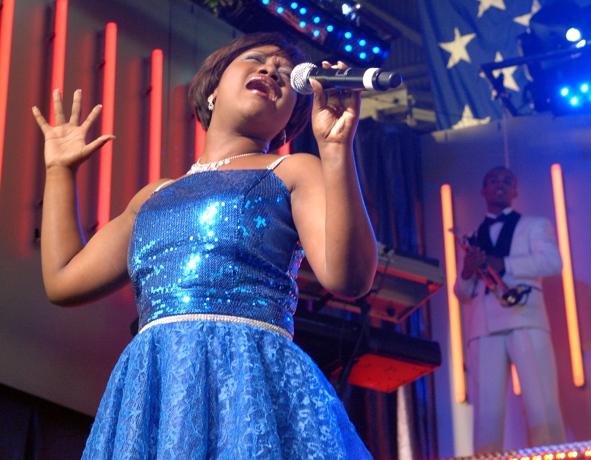 Airman 1st Class Alice Lewis performs “Somewhere over the Rainbow.”  Airman Lewis is a logistics plans apprentice with the 621st Contingency Response Wing, McGuire Air Force Base. Airman Lewis also performed a classic by Aretha Franklin, and had concert attendees rolling with the Tops In Blue rendition of “Proud Mary”. (U.S. Air Force photo by Staff Sgt. Tyrona Pearsal)