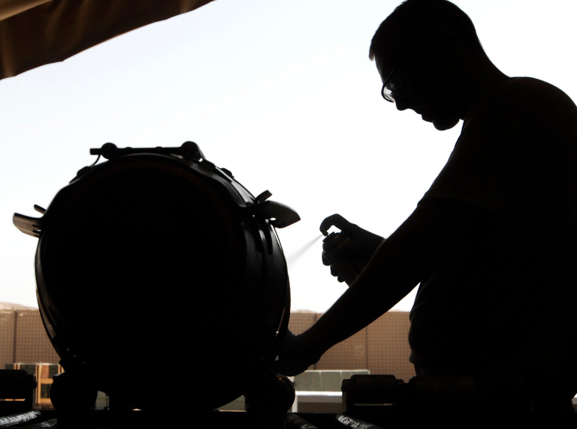 JOINT BASE BALAD, Iraq -- Airman 1st Class Jon Elkins spray paints a location number onto a GBU-38 Joint Direct Attack Munition here Aug. 7. The JDAM contains an inertial navigational system and a GPS guidance control unit that improves the accuracy of general purpose bombs in any weather condition. Airman Elkins is a munitions handler with the 332nd Expeditionary Maintenance Squadron and is deployed from Fairchild Air Force Base, Wash. His hometown is Tucson, Ariz. (U.S. Air Force photo/Airman 1st Class Jason Epley)