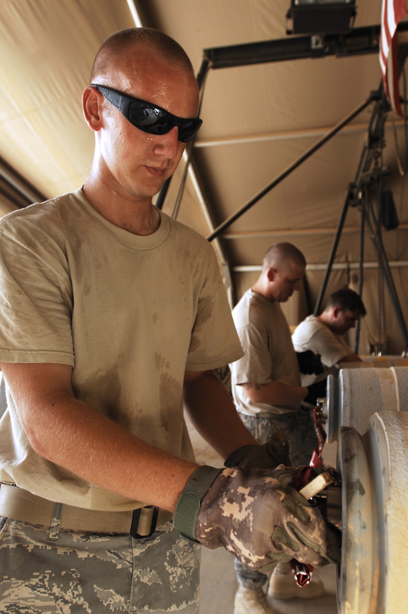 JOINT BASE BALAD, Iraq -- Staff Sgt. Tom Dulley cleans the threading inside the fuse well on a GBU-38 Joint Direct Attack Munition here Aug. 7. The JDAM contains an inertial navigational system and a GPS guidance control unit that improves the accuracy of general purpose bombs in any weather condition. Sergeant Dulley, a munitions handler with the 332nd Expeditionary Maintenance Squadron, is deployed from Shaw Air Force Base, S.C., and is originally from Cedar Hill, Tenn. (U.S. Air Force photo/Airman 1st Class Jason Epley)