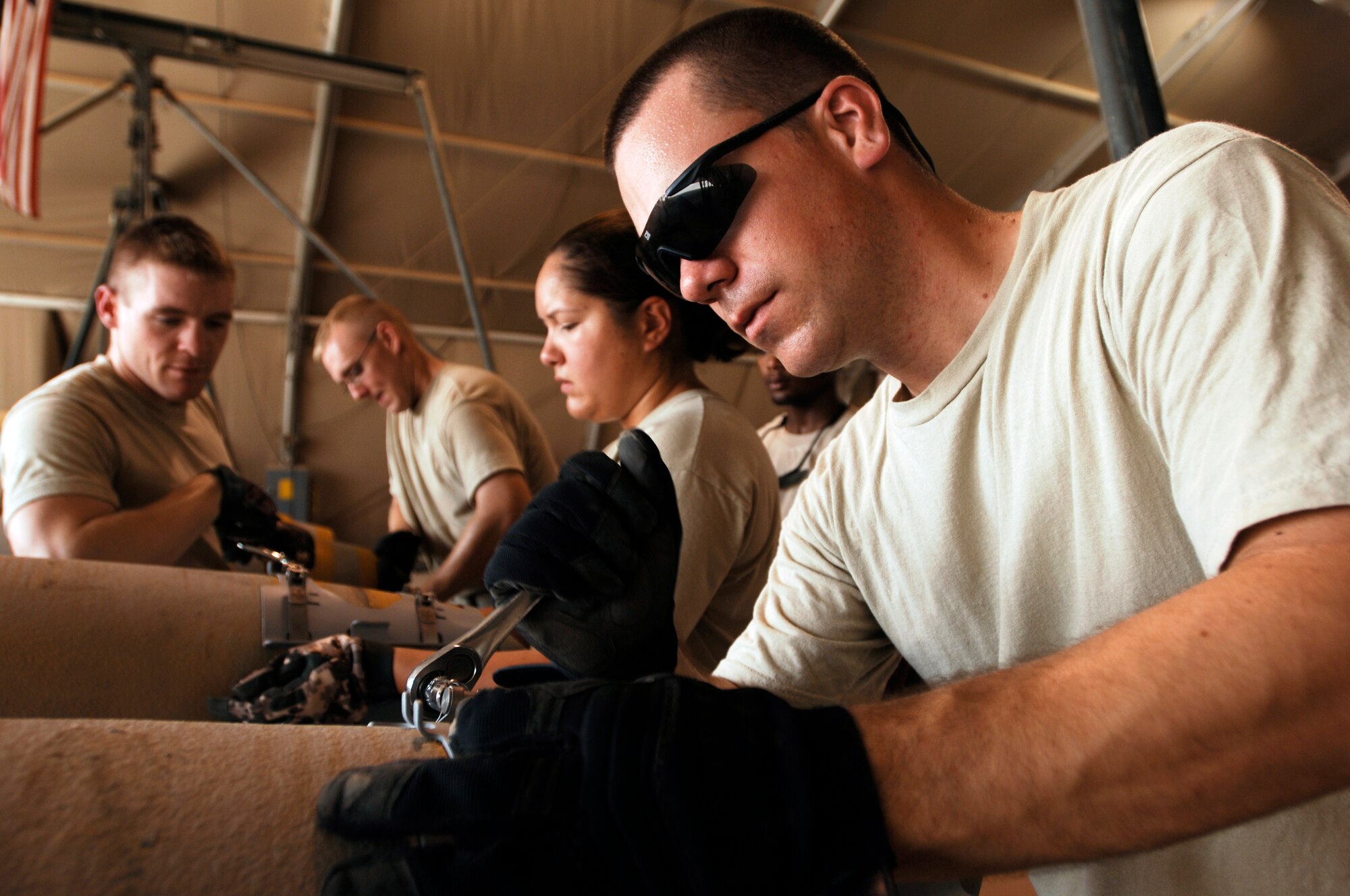 JOINT BASE BALAD, Iraq -- Staff Sgt. Nick Blumer installs a strake assembly onto a GBU-38 Joint Direct Attack Munition here Aug. 7. The JDAM contains an inertial navigational system and a GPS guidance control unit that improves the accuracy of general purpose bombs in any weather condition. Sergeant Blumer, a munitions handler with the 332nd Expeditionary Maintenance Squadron, is deployed from Joe Foss Field Air Guard Station, S.D. (U.S. Air Force photo/Airman 1st Class Jason Epley)