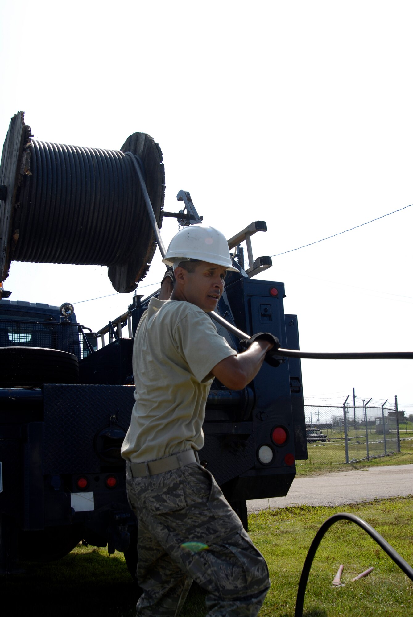 U.S. Air Force Senior Airman George Perez Jr., 8th Communications Squadron Cable Technician, pulls communication cable that will be laid to enable faster communication with the F-16 pilots assigned to Kunsan AB, South Korea, 08 Aug 2008. Faster communication allows leaders to be relayed up to the moment battle statistics, helping them make better decisions. (U.S. Air Force photo/Staff Sgt. Jason Colbert)