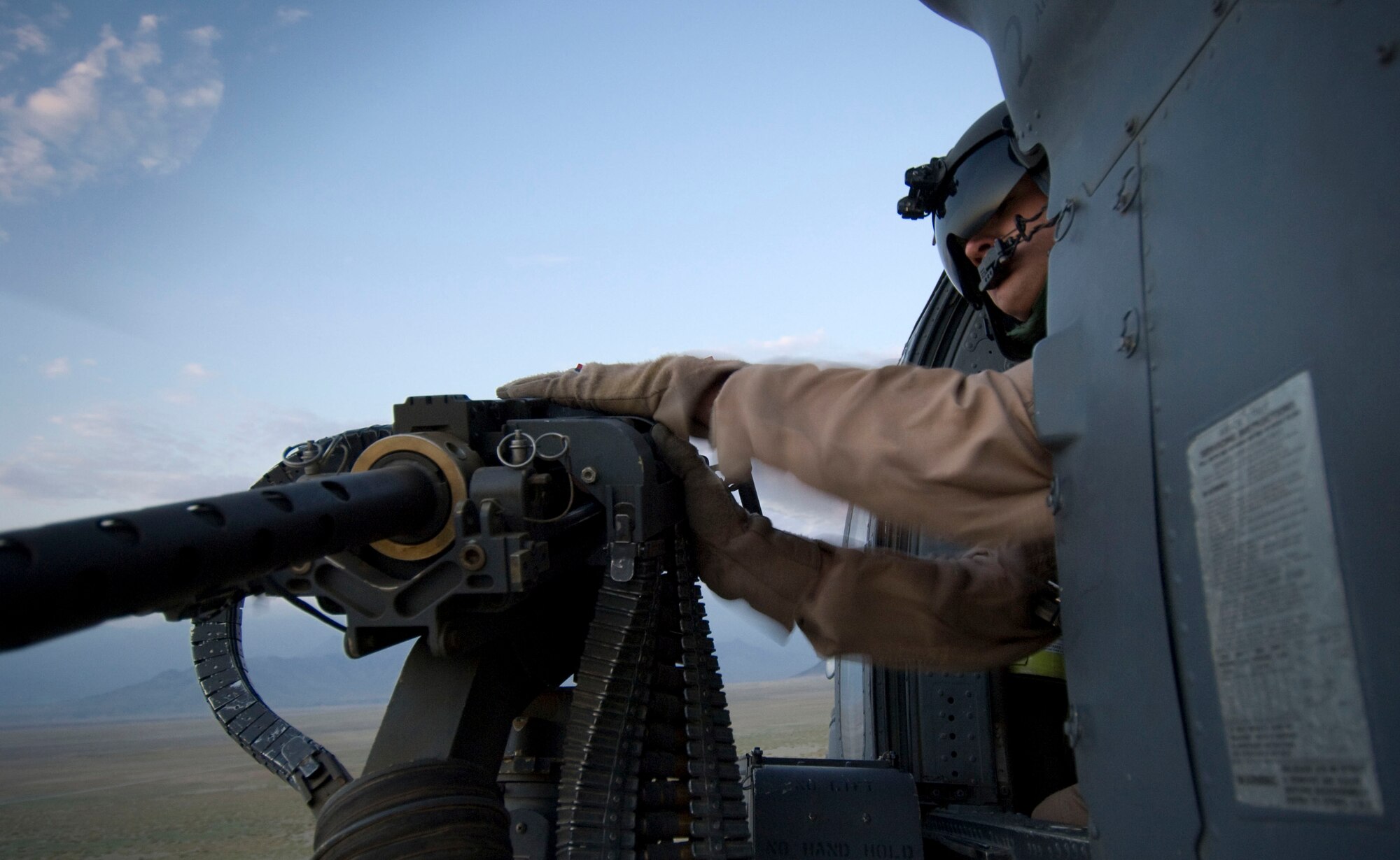 BAGRAM AIR FIELD, Afghanistan -- Senior Airman Ryan Ballinger, 33rd Expeditionary Rescue Squadron gunner, clears a jam in his 50-calibur machinegun onboard an HH-60G Pave Hawk here on August 2, 2008. As an aerial gunner, Airman Ballinger provides security for combat search and rescue missions. Airman Ballinger is deployed from the 33rd Rescue Squadron, Kadena Air Base, Japan. (U.S. Air Force photo by Staff Sgt. Samuel Morse)