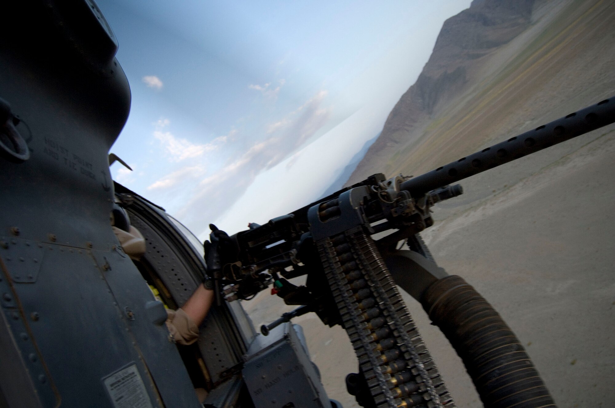 BAGRAM AIR FIELD, Afghanistan -- Staff Sgt. Gerald Messier, 33rd Expeditionary Rescue Squadron flight engineer, operates the 50-calibur machinegun in an HH-60G Pave Hawk here on August 2, 2008. As a flight engineer, Sergeant Messier is charged providing the pilots critical situational information during flight. Sergeant Messier is deployed from the 33rd Rescue Squadron, Kadena Air Base, Japan, and hails from Fairfield, Vt. (U.S. Air Force photo by Staff Sgt. Samuel Morse)