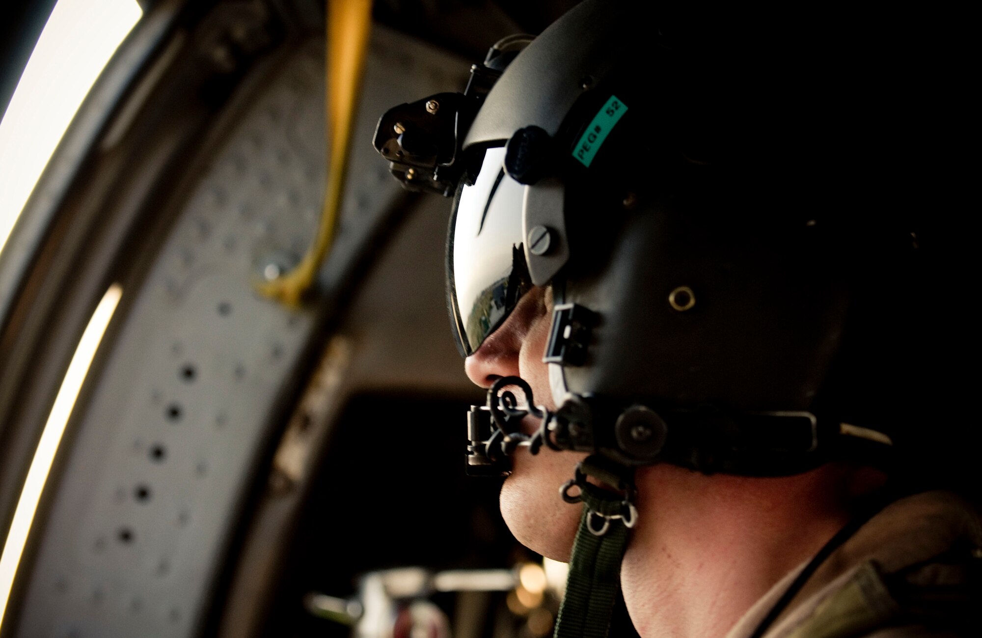 BAGRAM AIR FIELD, Afghanistan -- Senior Airman Ryan Ballinger, 33rd Expeditionary Rescue Squadron gunner, looks out at the surrounding area here on August 2, 2008. As an aerial gunner, Airman Ballinger is tasked operating a 50-calibur machinegun and keeping a wary eye for enemy movement. Airman Ballinger is deployed from the 33rd Rescue Squadron, Kadena Air Base, Japan. (U.S. Air Force photo by Staff Sgt. Samuel Morse)