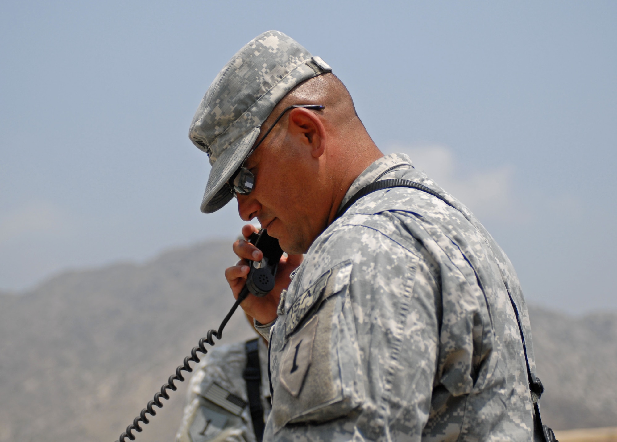 Army Sgt. 1st Class Ronald Valdez, 1st Battalion, 6th Field Artillery, 3rd Brigade Combat Team, 1st Infantry Division, gun line NCO-in charge, gets mission information from the Joint Operations Center on the radio, at Forward Operating Base Kala Gush, Afghanistan, July 30. (U.S. Army photo/ Staff Sgt. Adora Medina)
