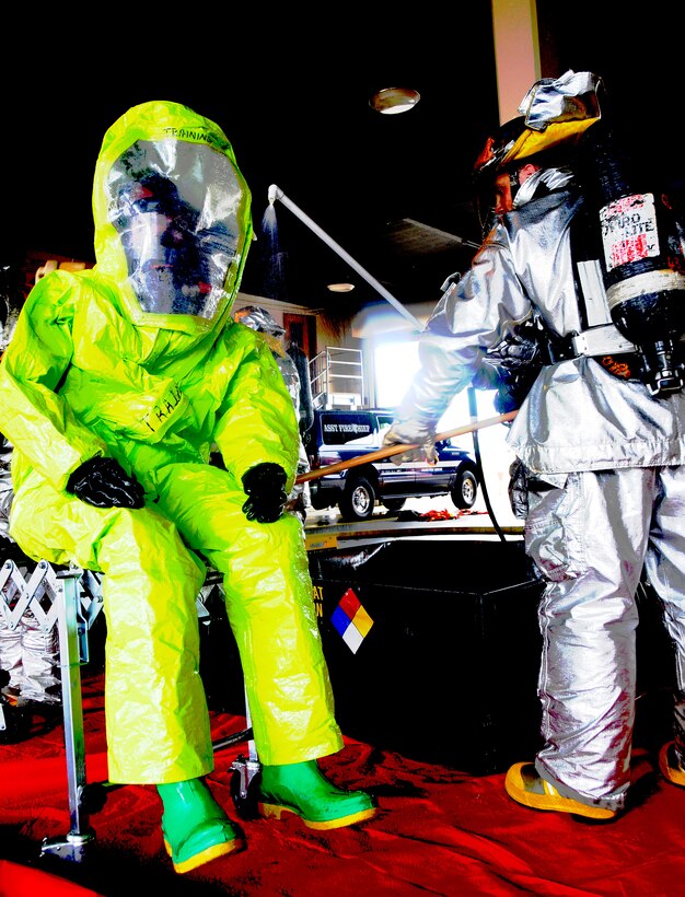 ANDERSEN AIR FORCE BASE, Guam- Senior Airman Mark Maslowski (right), 36th Civil Engineer Squadron fire fighter, decontaminates Senior Airman Nathan Fullerton (left) during a hazardous materials exercise at Andersen's Fire Station One Aug. 6. Teams from the 36th Civil Engineer Squadron's emergency management flight and the 36th Medical Group's bioenviromental element also took part in the HAZMAT exercise. (U.S. Air Force photo by Airman 1st Class Courtney Witt)