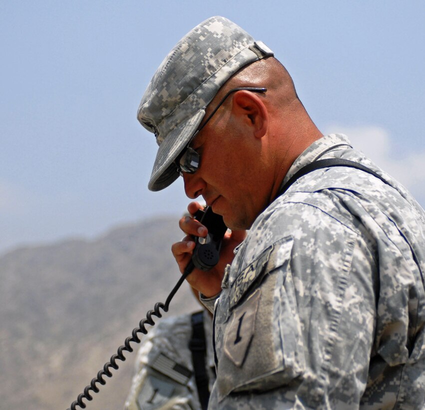 Army Sgt. 1st Class Ronald Valdez, 1st Battalion, 6th Field Artillery, 3rd Brigade Combat Team, 1st Infantry Division, gun line NCO in charge, gets mission information from the Joint Operations Center on the radio, at Forward Operating Base Kala Gush, Afghanistan, July 30, 2008. U.S. Army photo by Staff Sgt. Adora Medina,  3rd Brigade Combat Team, 1st Armored Division