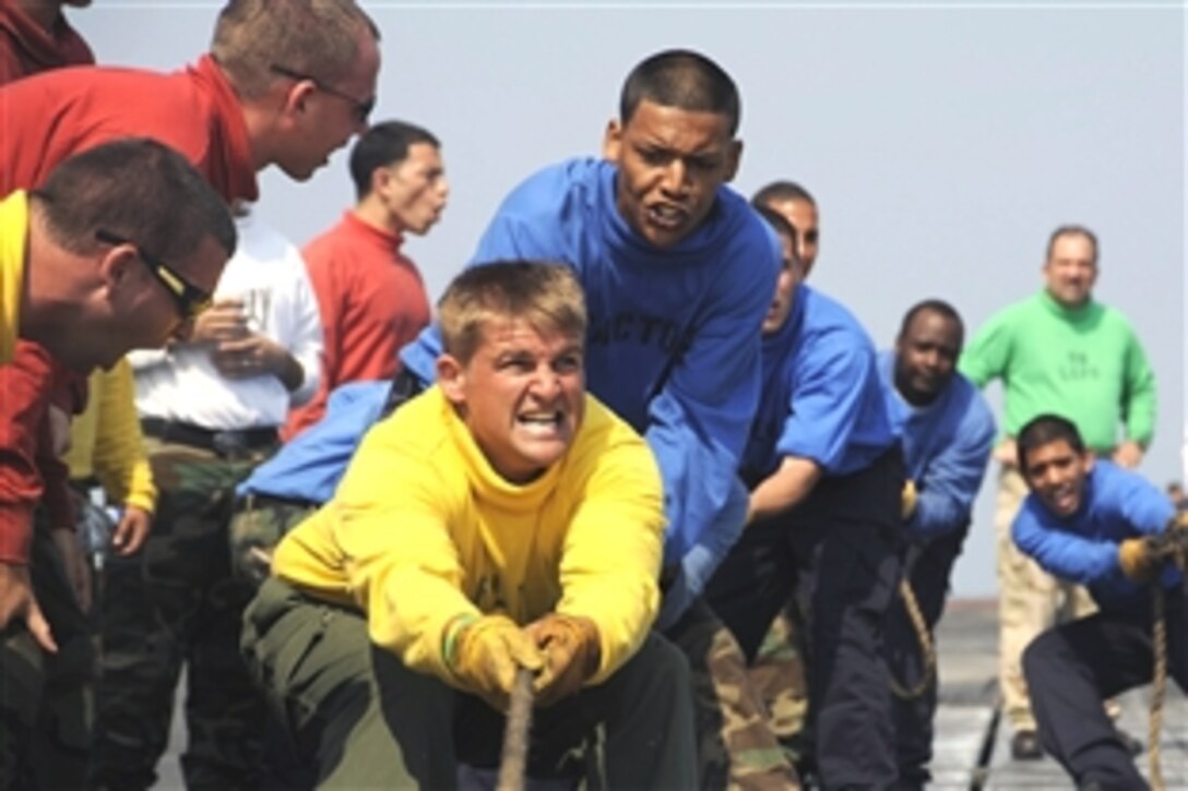 U.S. sailors assigned to Air Departments V-1 Division participate in a shuttle pull during Flight Deck Olympics aboard the Nimitz-class aircraft carrier USS Theodore Roosevelt in the Atlantic Ocean, Aug 7, 2008. The USS Roosevelt is conducting operations off the Atlantic Coast. 