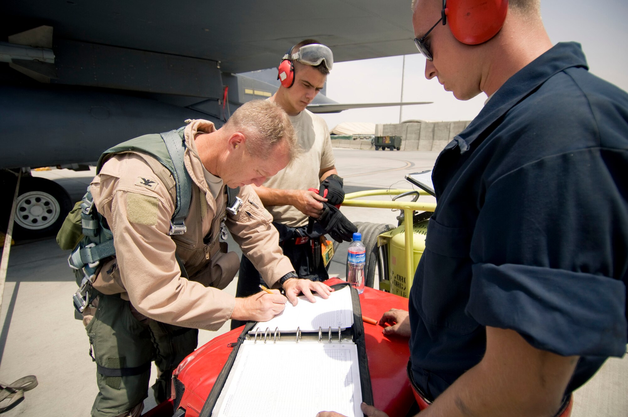BAGRAM AIR FIELD, Afghanistan -- Col. Mark Kelly, 455th Air Expeditionary Wing vice commander fills out a logbook after flying in an F-15E Strike Eagle here on August 1, 2008. Everything is carefully documented to ensure a proper history for the aircraft to anticipate and prevent maintenance issues in the future. (U.S. Air Force photo by Staff Sgt. Samuel Morse)