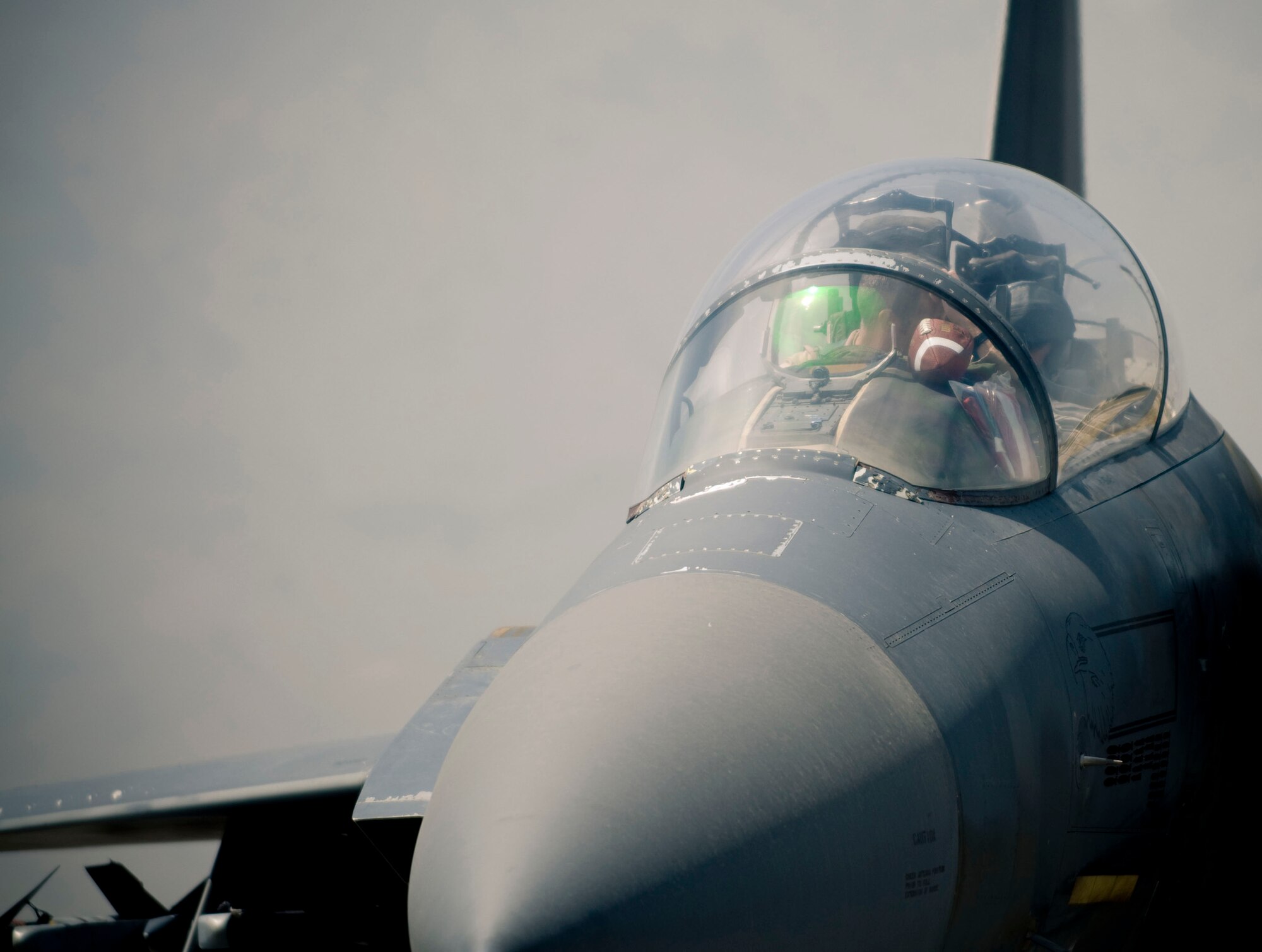 BAGRAM AIR FIELD, Afghanistan -- A small football sits next to the heads up display of an F-15E Strike Eagle here on August 1, 2008. The football was flown for a sick child who was no longer able to play football. (U.S. Air Force photo by Staff Sgt. Samuel Morse)