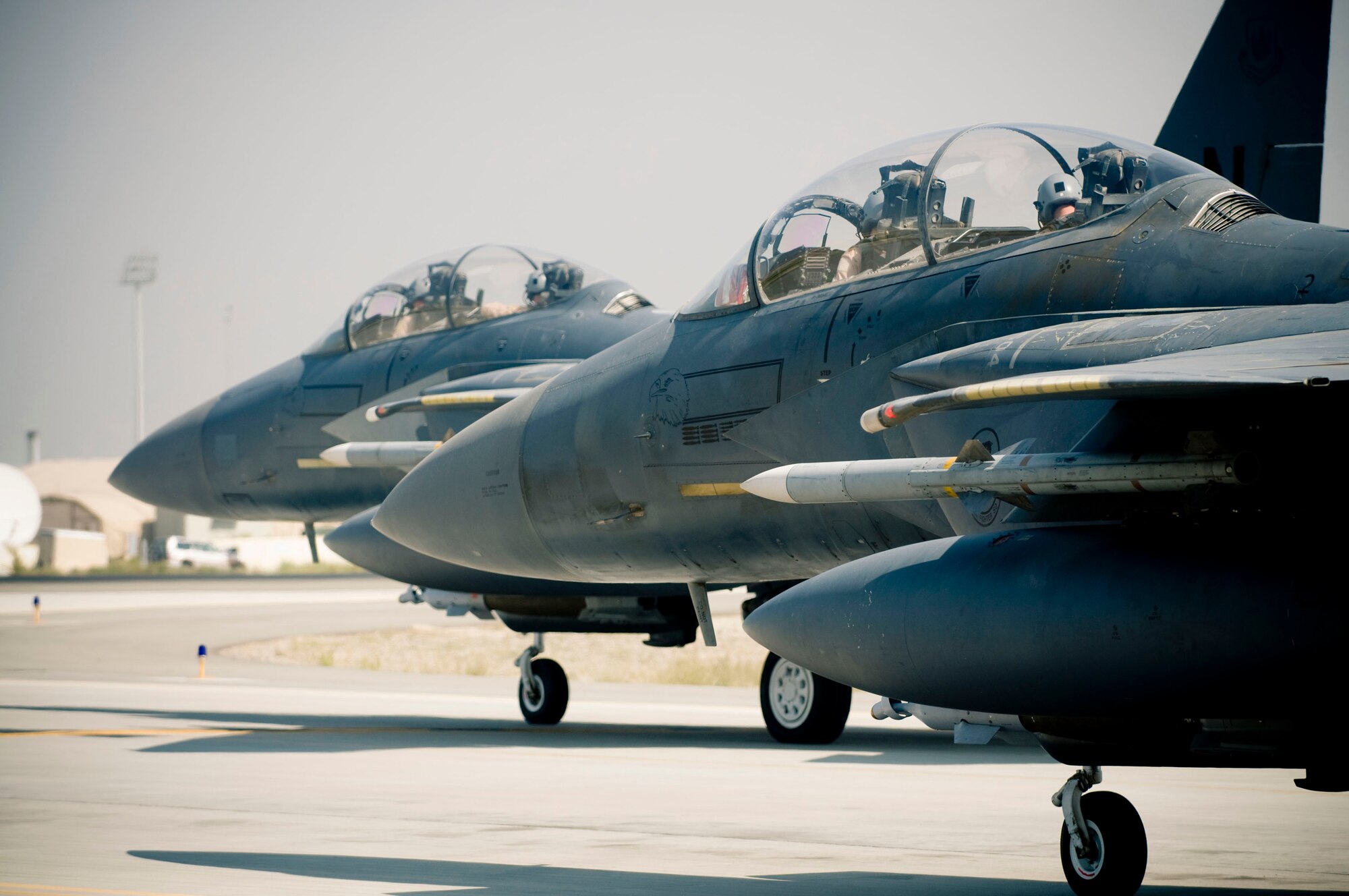 BAGRAM AIR FIELD, Afghanistan -- Two F-15E Strike Eagles taxi out to the runway here on August 1, 2008. Pilots take the Air Force "wingman" concept to heart, ensuring safety and mission success by always working in pairs. (U.S. Air Force photo by Staff Sgt. Samuel Morse)