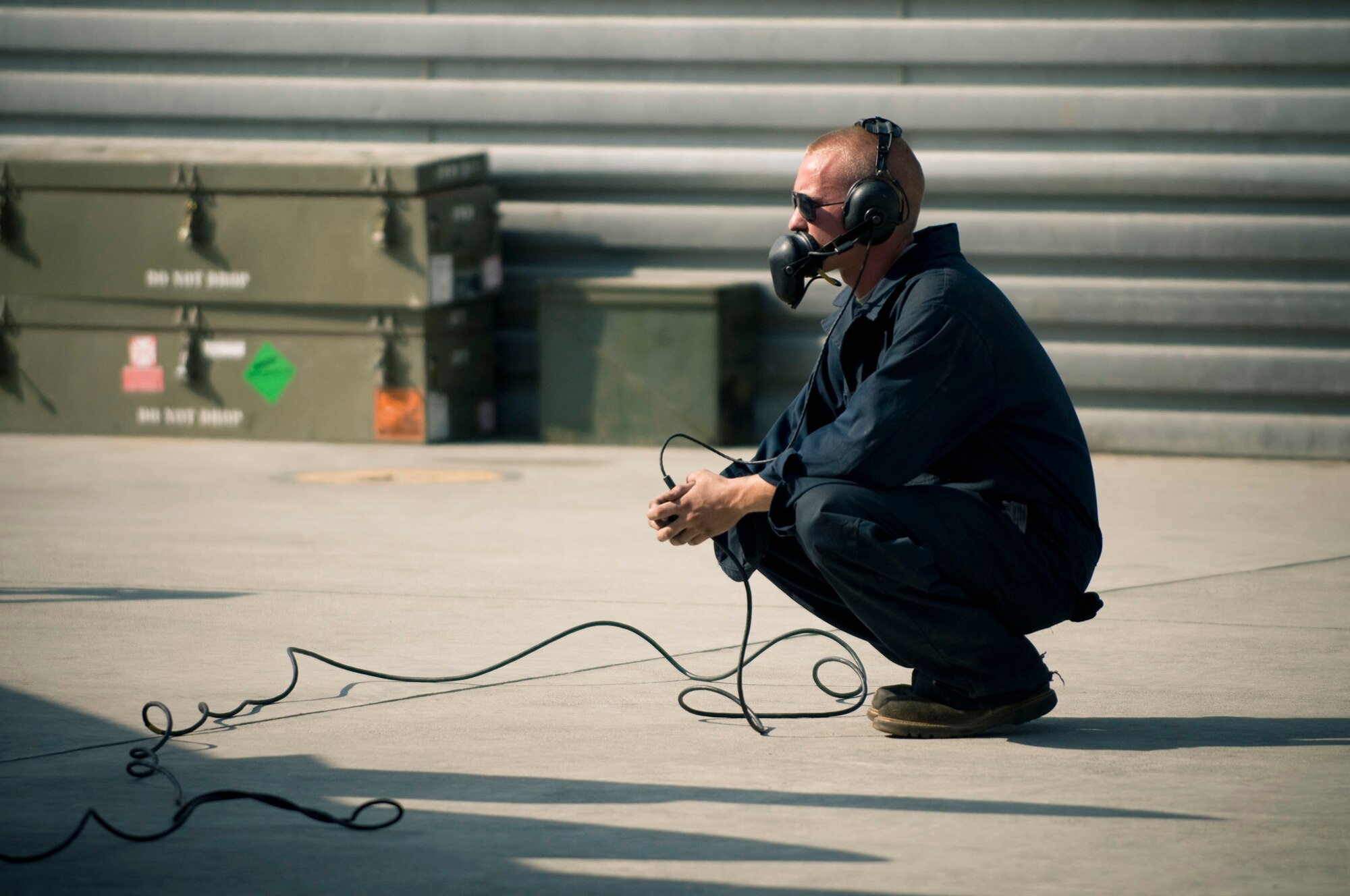 BAGRAM AIR FIELD, Afghanistan -- Senior Airman Mathew Mains, 494th Expeditionary Aircraft Maintenance Unit crew chief, watches the underbelly of an F-15E Strike Eagle here on August 1, 2008. Airman Mains serves as the pilot's eyes and ears outside the aircraft during engine ignition and preflight to make sure everything is working correctly. Airman Mains is deployed from the 494th Aircraft Maintenance Unit, RAF Lakenheath, England. (U.S. Air Force photo by Staff Sgt. Samuel Morse)