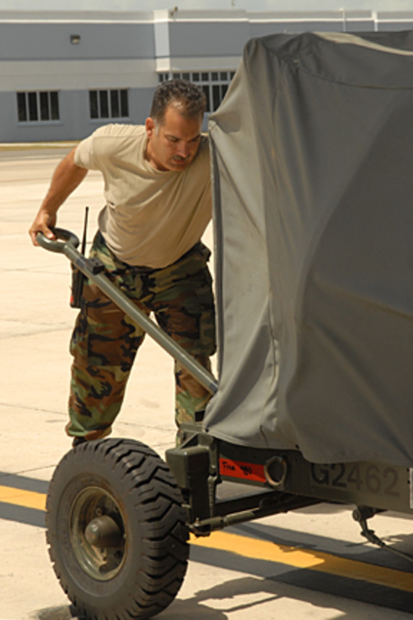 Master Sgt. Carl Shaffer of the 123rd Maintenance Squadron positions ground equipment to load onto a C-130 aircraft during the wing's successful airlift support of Southern Command operations. (Tech. Sgt. Diane Stinnett/KyANG)