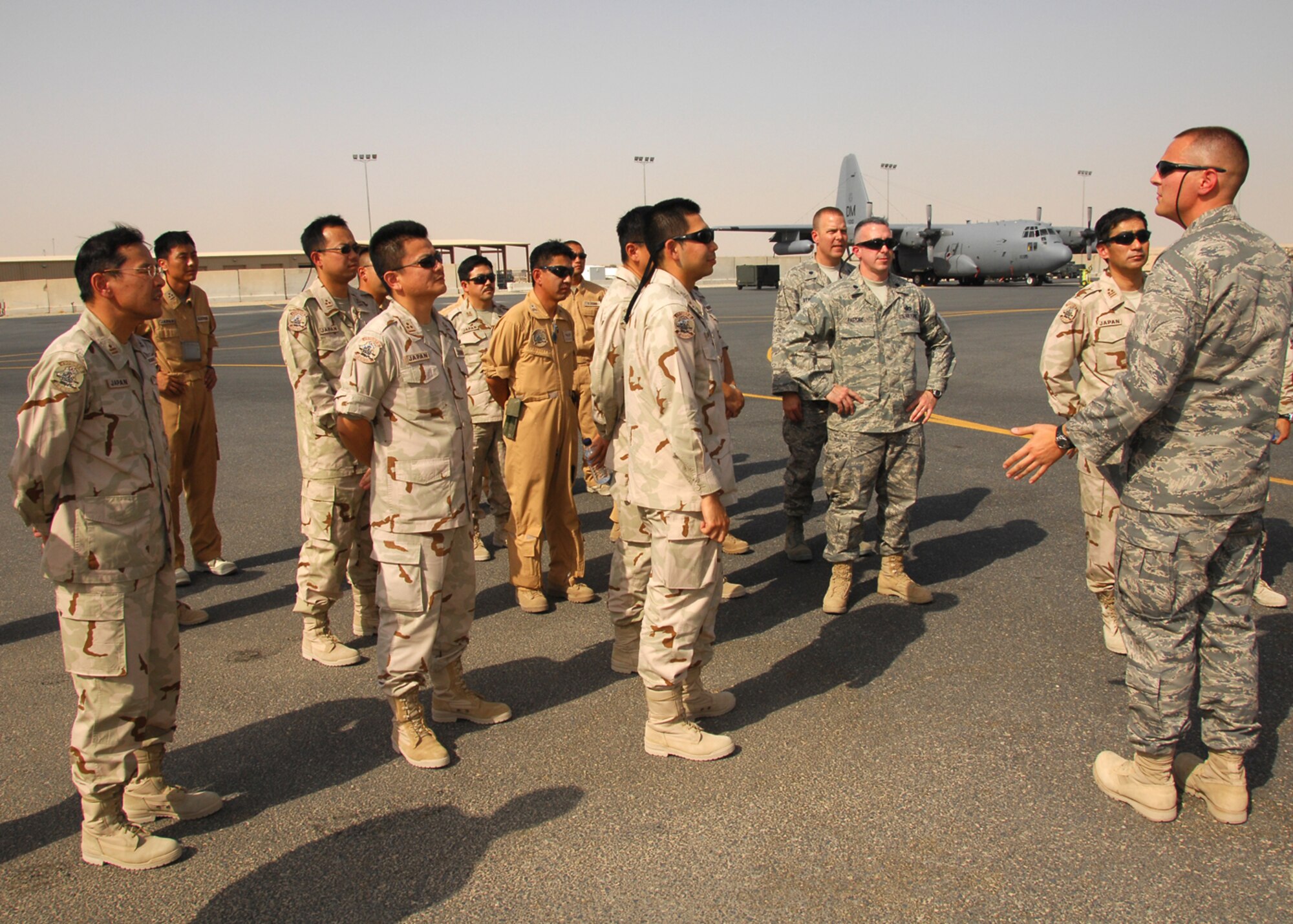 SOUTHWEST ASIA -- 1st Lt. David Marques, 386th Silver Aircraft Maintenance Unit officer in charge, briefs Japan Air Self-Defense Force members on the capabilities of a EC-130H Compass Call at a base in Southwest Asia. The brief was part a coalition maintenance exchange program between the U.S. Air Force, JASDF and the Republic of Korea Air Force, which promotes an exchange of aircraft maintenance ideas and practices between them. (U.S. Air Force photo/Tech. Sgt. Raheem Moore)
