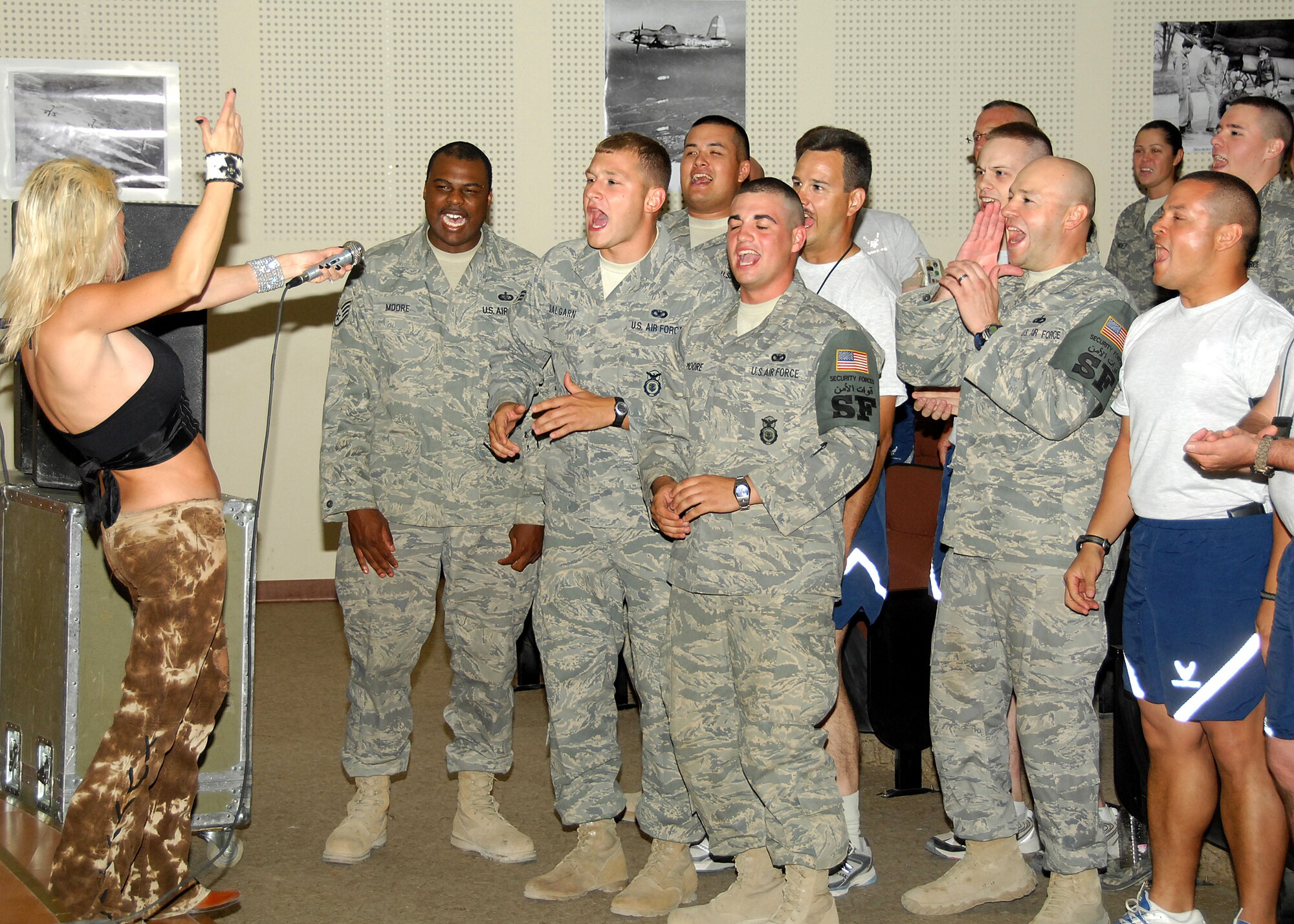 SOUTHWEST ASIA -- Shelby Goff, lead vocalist for the band Beautiful Generation, gets maximum crowd participation during an energetic rock show on Aug. 8 at a base in Southwest Asia. This was the first stop on the band?s Operation Enduring Freedom Tour, which is sponsored by the United Service Organizations. The tour will take them to Iraq, Italy and Germany to entertain military members serving overseas. (U.S. Air Force photo/Tech. Sgt. Raheem Moore)
 
