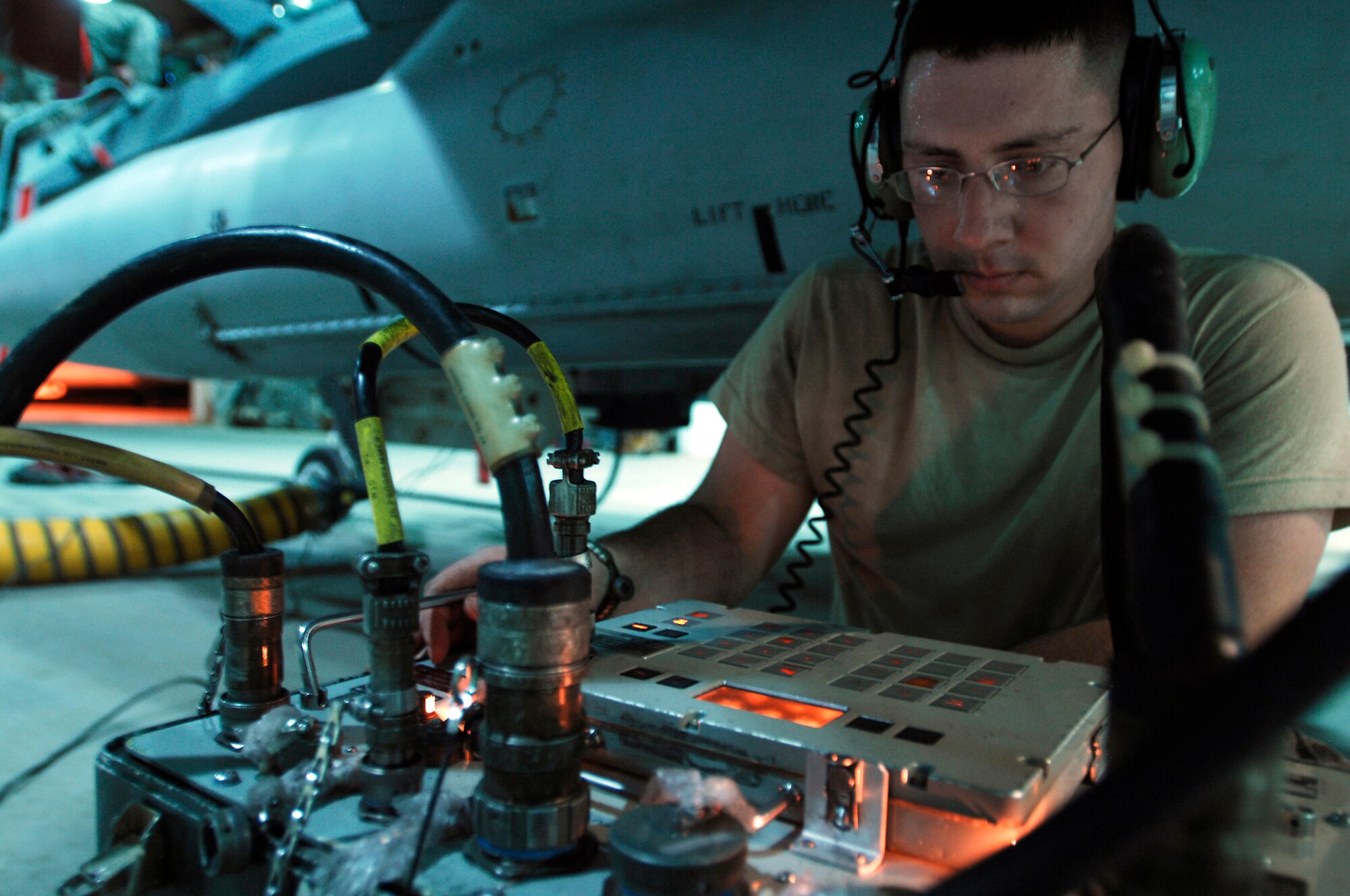 JOINT BASE BALAD, Iraq -- Staff Sgt. William Houston uses a 501 tester to check for a proper signal between a newly installed wing weapons pylon and an F-16 Fighting Falcon's computer. Communication between the aircraft's computer and weapons pylon allows the pilot to accurately deploy the proper weapon to complete the mission. Sergeant Houston, a weapons crewmember with the 332nd Expeditionary Aircraft Maintenance Squadron here, is deployed from Hill Air Force Base, Utah. (U.S. Air Force photo/Airman 1st Class Jason Epley)