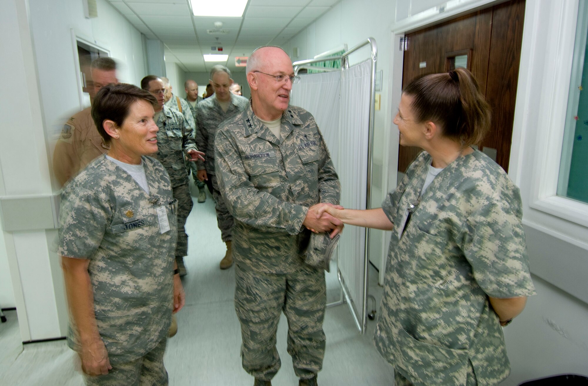 BAGRAM AIR FIELD, Afghanistan -- Chaplain (Maj. Gen.) Cecil R. Richardson (center), Air Force Chief of Chaplains, shakes hands with Tech. Sgt. Traci Wilmoth (right), NCO in charge of the intensive care wing, here on August 4, 2008. Chaplain Richardson toured the task force medical facility here at Bagram during his visit to boost moral and ensure the spiritual well-being of deployed Airmen across southwest Asia. (U.S. Air Force photo by Staff Sgt. Samuel Morse)