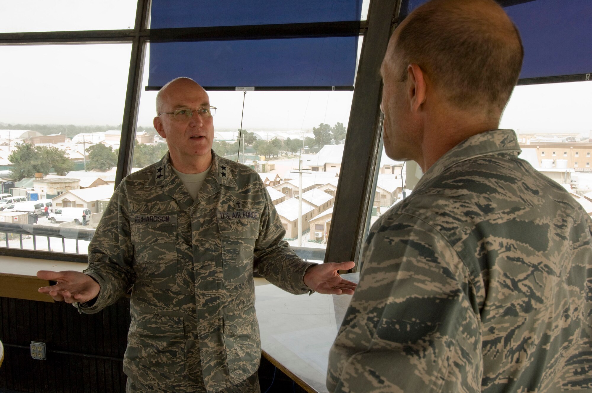 BAGRAM AIR FIELD, Afghanistan -- Chaplain (Maj. Gen.) Cecil R. Richardson, Air Force Chief of Chaplains, and Brig. Gen. Mike Holmes, 455th Air Expeditionary Wing commander, discuss important matters concerning the spiritual welfare of the men and women of 455th AEW. The two generals met in the "Crow's Nest," the old control tower overlooking Camp Cunningham, after eating lunch together. (U.S. Air Force photo by Staff Sgt. Samuel Morse)
