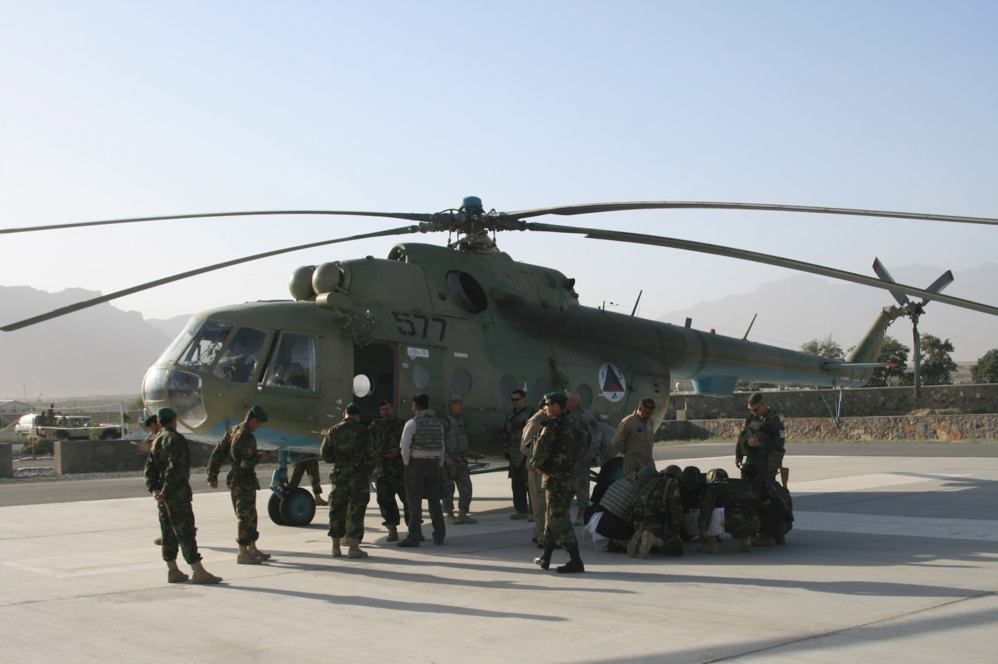 Afghan National Army troops, with their Coalition forces counterparts, discuss landing information before heading out to do an air reconnaissance mission in the Jowzak area. This recon was the first all-ANA-led air operation and the ANA used their own pilots and resources to accomplish the mission. Coalition forces provided support. (Courtesy photo)