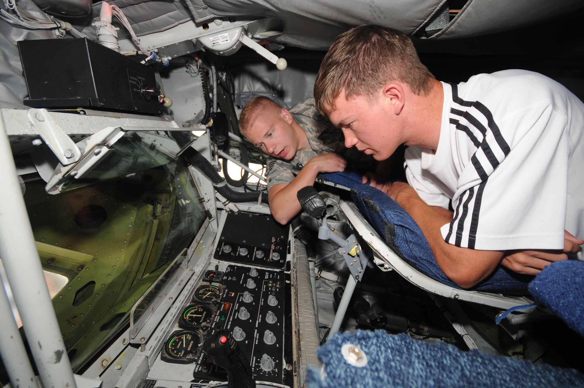 Staff Sgt. Bradley Harris, 151st Air Refueling Wing, shows a student the inside of a KC-135 Stratotanker during a Freedom Academy tour of the Utah Air National Guard Base on Aug.6.  Freedom Academy is a week-long leadership camp designed for high school student body officers from schools throughout Utah.  It is hosted by members of the Utah Army and Air National Guard, and focuses on the theme of "freedom."  (USAF photo by Tech Sgt. Mike Evans)