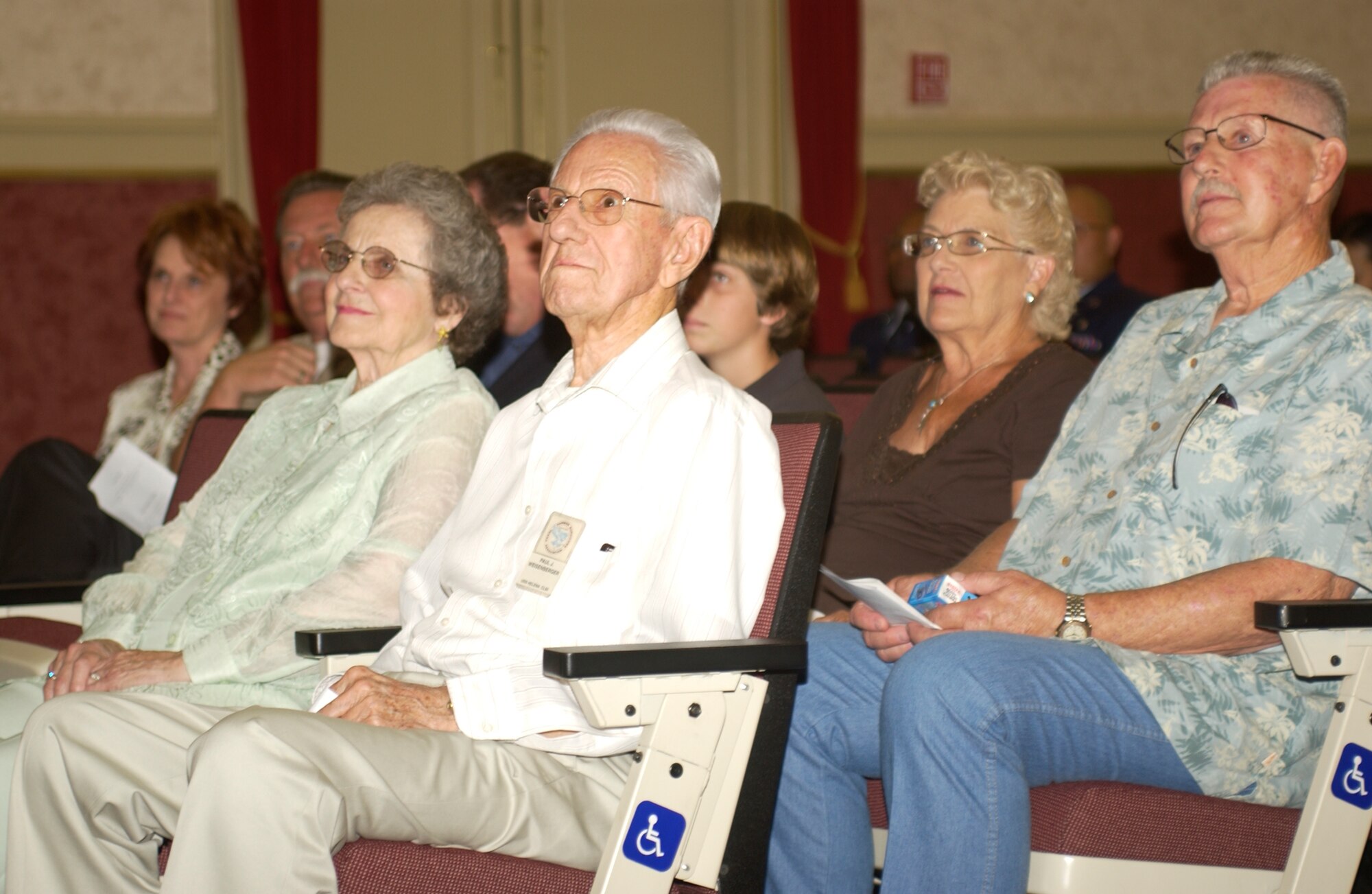 The parents of Col. Robert J. Weisenberger (left) watch in the audience as he takes command of the 452nd Medical Group. (U.S. Air Force photo by Capt. Caroline Lorimer)