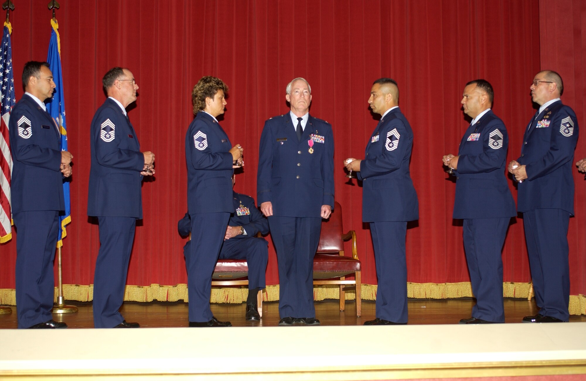 HONORARY CHIEF: Members of the 452 AMW Chiefs’ Group bestow the rank of honorary chief master sergeant to Colonel Raymond M. Butler, former 452nd Medical Group commander (center), during his retirement ceremony at the Cultural Resource
Center, Sunday, which inducts him into the group. The gesture is the highest tribute chiefs can pay to a leader. (U.S. Air Force photo by Capt. Caroline Lorimer)