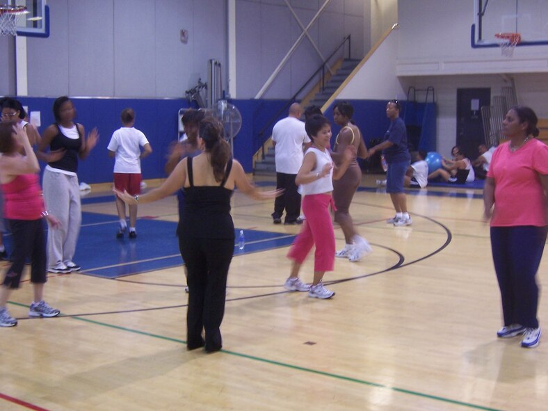 A DANCE WORKOUT: A group of participants in the Air Force Promotion Salsa Mix try to get their moves down. Dance instructors Pam Smith and David and Martha Paez taught the fun class to 26 enthused participants. Dancers learned Salsa, Cumbia, Bachata, Merengue and Cha Cha Cha. (U.S. Air Force photo by Pam Smith) 