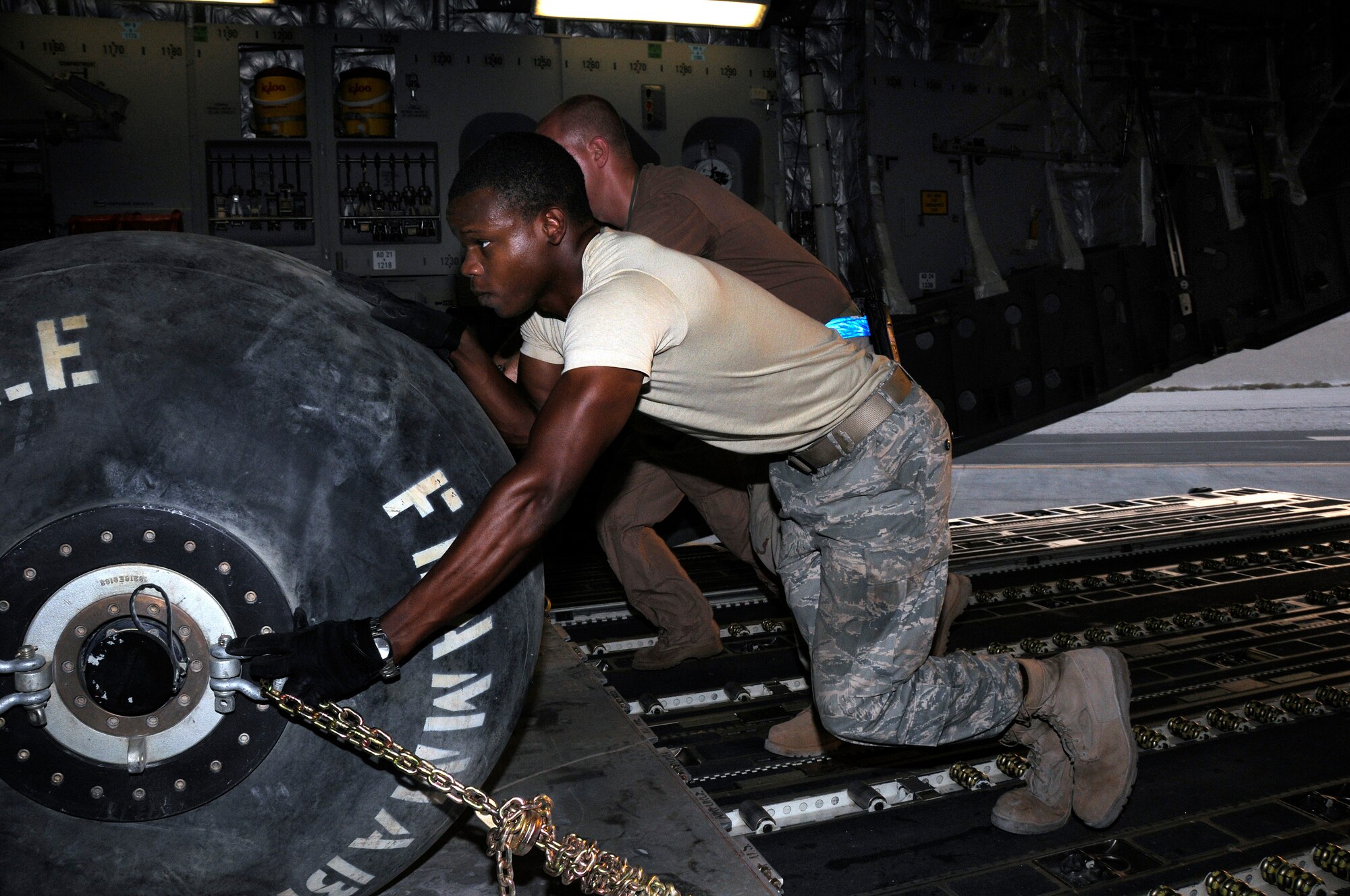Airman 1st Class Micheal Coles, 8th Expeditionary Air Mobility Squadron (EAMS) from Charleston Air Force Base, S.C., helps move a heavy pallet into position on the C-17 Globemaster III at an undisclosed air base in Southwest Asia Aug. 8, 2008.  Airmen Coles, along with other EAMS personnel and C-17 aircrew, work together to load pallets of equipment and supplies for delivery up range in support of Operations Iraqi Freedom and Enduring Freedom.  (U.S. Air Force photo by Tech. Sgt. Michael Boquette/Released)