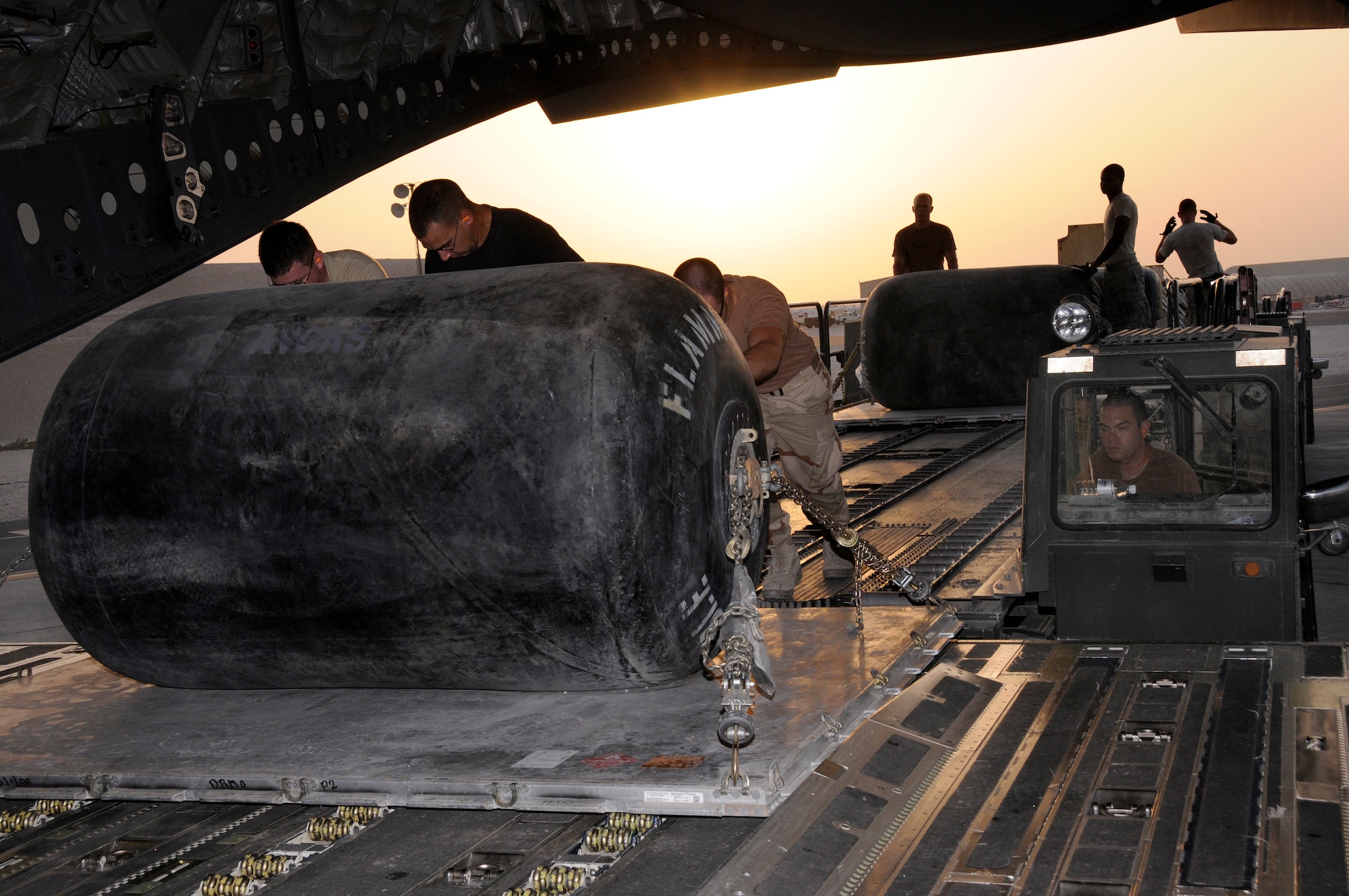 Senior Airman Matthew Brandt, 8th Expeditionary Air Mobility Squadron, manipulates a 60K loader to assist in off-loading pallets onto a C-17 Globemaster III aircraft at an undisclosed air base Aug. 8, 2008.  The equipment and supplies loaded are destined for bases up range in support of Operations Iraqi and Enduring Freedom. Airman Brandt is deployed from Royal Air Force Mildenhall, United Kingdom. (U.S. Air Force photo by Tech. Sgt. Michael Boquette/Released)
