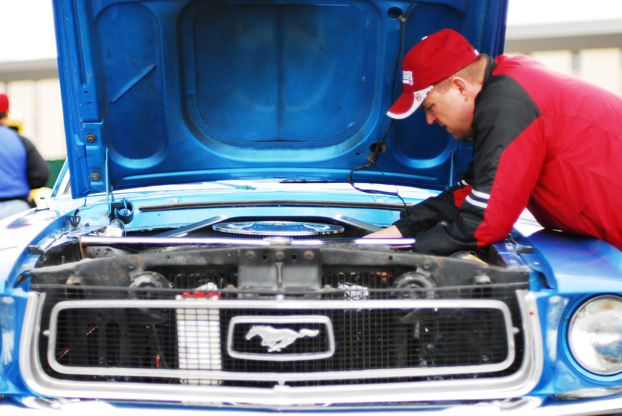 Tech. Sgt. Charley Helvy, 354th Logistics Readiness Squadron, inspects his 1968 Ford Mustang coupe before the second Iceman Car and Motorcycle Show sponsored by 354th Force Support Squadron Aug. 9, 2008, at Eielson Air Force Base, Alaska. Prizes were awarded for best motorcycle, best truck, and best current model vehicle and people's choice. (U.S. Air Force photo by Airman 1st Class Jonathan Snyder)