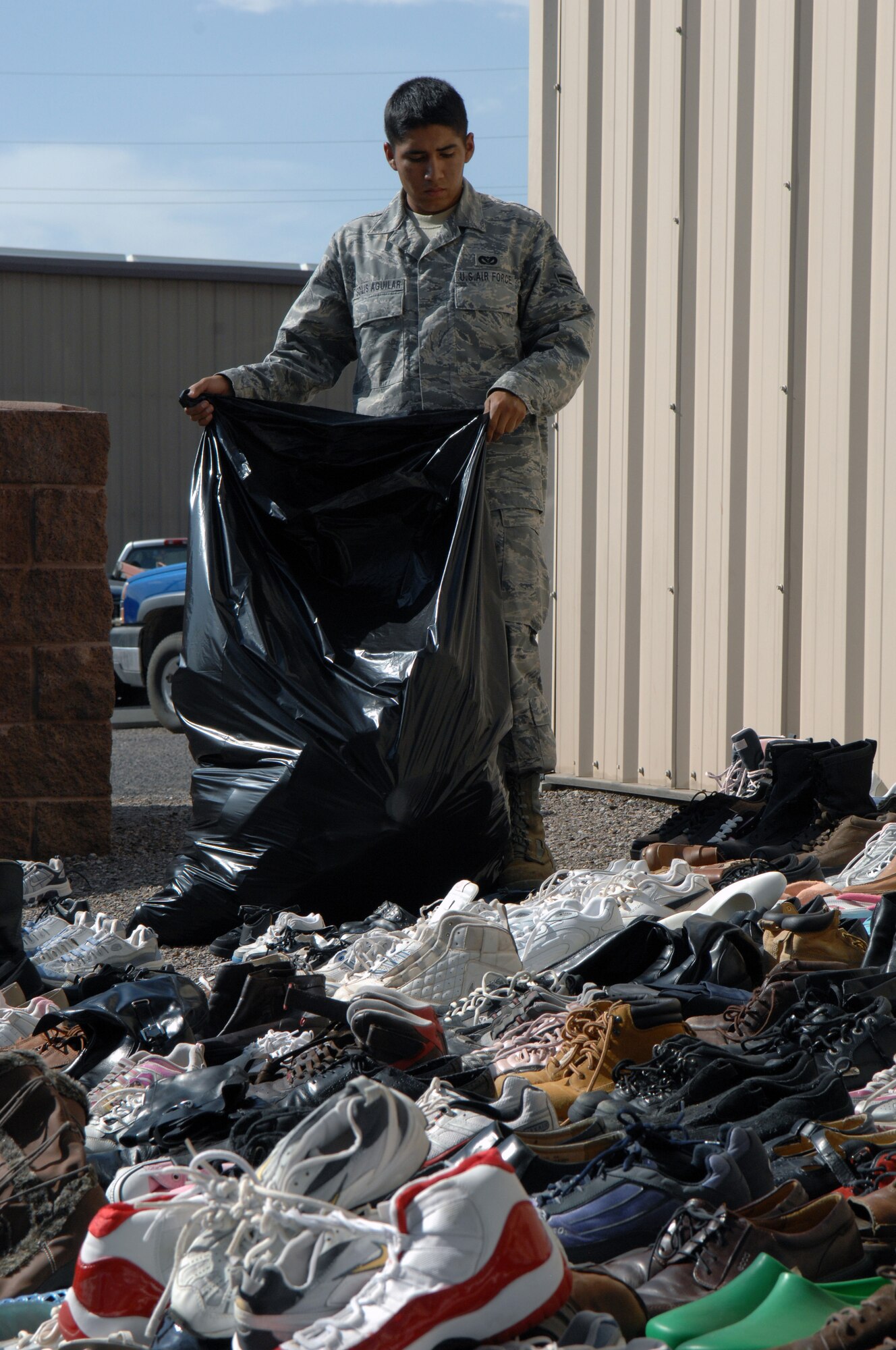 Airman 1st Class Jose Solis-Aguilar, 49th Civil Engineer Squadron, places donated shoes in trash bags at Holloman Air Force Base, N.M., Aug. 6. All donations will be sent to areas of Africa and Afghanistan.
(U.S. Air Force photo/Senior Airman Anthony Nelson Jr)

