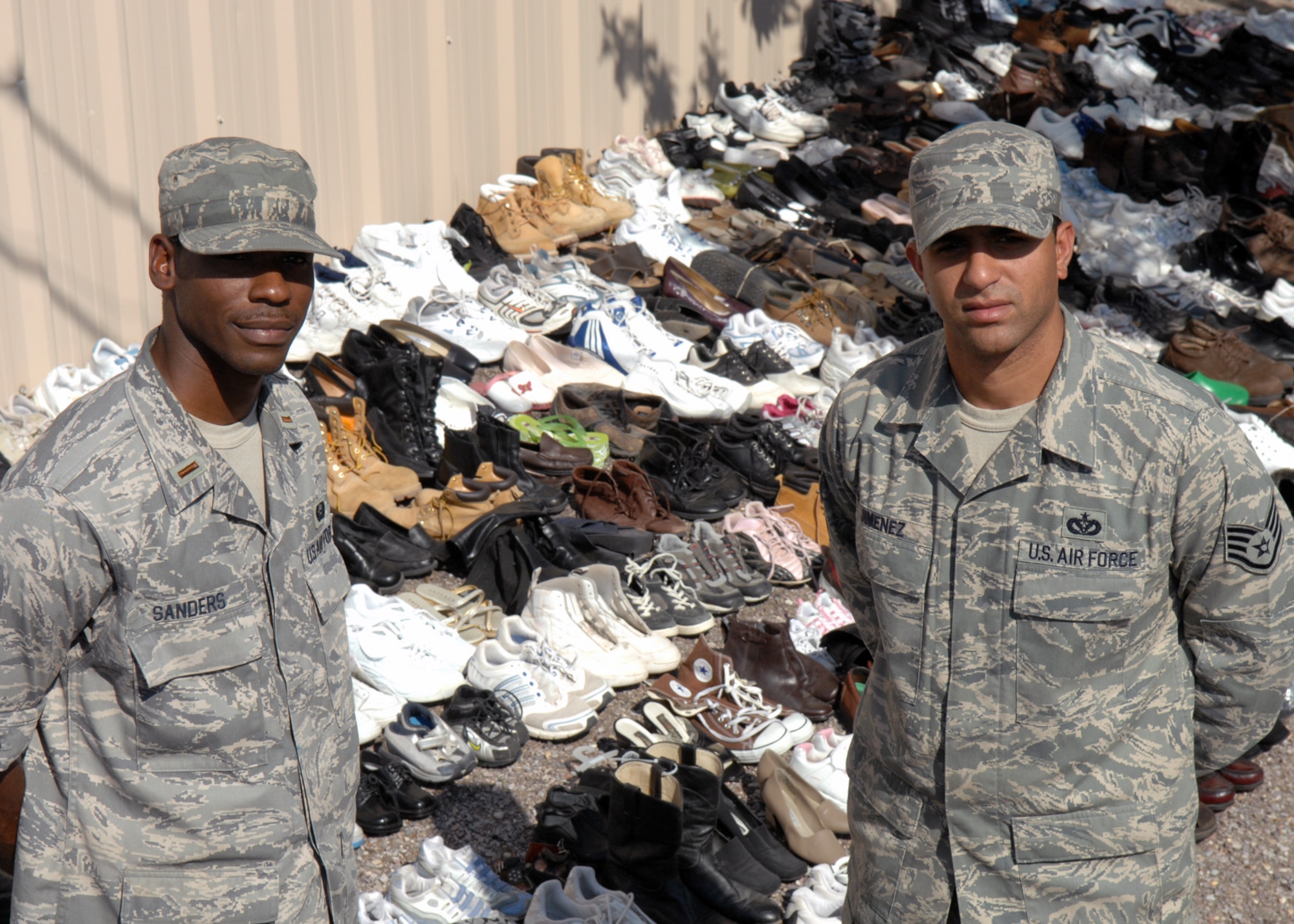 (Left to Right) 2nd Lt. Brandon Sanders, 49th Civil Engineer Squadron, and Staff Sgt. Braulio Jimenez, also from the 49th CES, pose for a picture in front of more than 500 pairs of shoes collected during the base wide shoe drive Aug. 5 at Holloman Air Force Base, N.M. All donations will be sent to areas of Africa and Afghanistan.
(U.S. Air Force photo/Senior Airman Anthony Nelson Jr)
