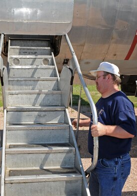 Joe Drab Jr., Ellsworth Heritage Program board member, prepares to close the C-131D "Samaritan," located at the South Dakota Air and Space Museum, after an inspection and inventory inside the plane, Aug. 6. The C-131D is one of thirteen planes adopted by the Adopt-a-Plane program. (U.S. Air Force photo/Airman Corey Hook)

