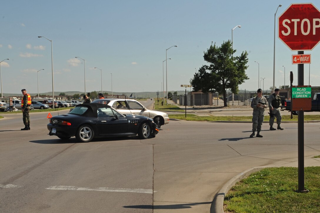 Members of the 28th Security Forces Squadron responded to a vehicular accident at the intersection of Spaatz Drive and Schriever Street here, Aug. 7. The 28th Bomb Wing Safety Office reminds Ellsworth drivers to be cautious of distractions while driving in order to prevent occurrences such as this in the future. The accident is currently under investigation. (U.S. Air Force photo by/Airman Corey Hook)