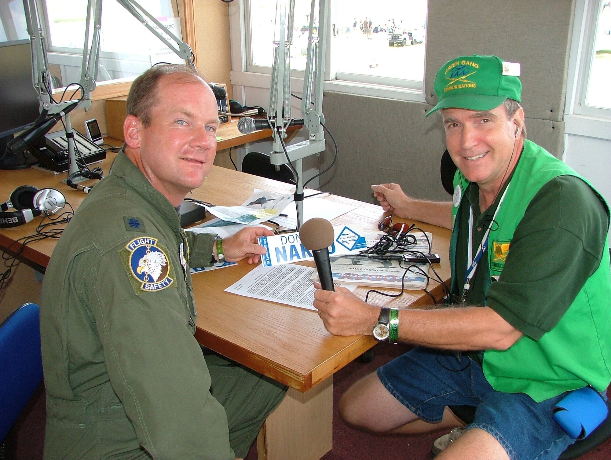 Rob Sturgeon, who also goes by Radio Rob, with Experimental Aircraft Association radio, interviews Lt. Col. Ned Linch, the 12th Air Force (Air Forces Southern) chief of flight safety during the   Experimental Aircraft Association Air Venture Oshkosh airshow in Oshkosh, Wisconsin where more than 540,000 civilians and military pilots from around the globe gathered July 31-Aug. 3 to showcase their planes and to compete for awards that recognize the best of the best.. The colonel is attending the airshow to educate general aviation and civilian pilots on midair collision avoidance and on the need for flight safety and planning awareness. 