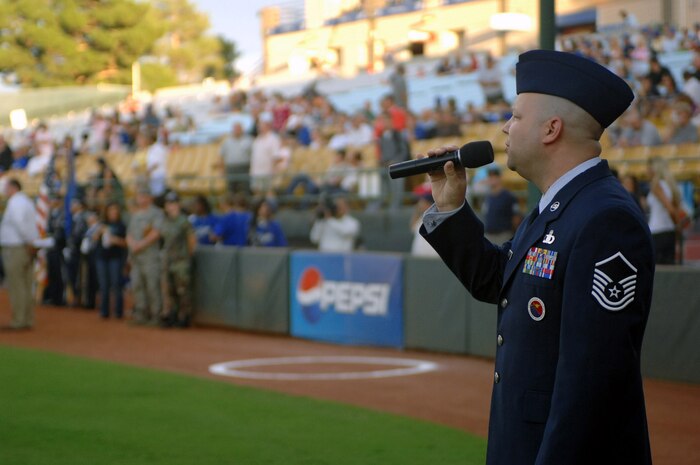 Master Sgt. Robert Brooks, 99th Airman Leadership School Flight chief, sings God Bless the USA before the Las Vegas 51s vs. Sacramento River Cats game at Cashman Field on Aug. 8, 2008, Las Vegas. More than 400 tickets were donated to Nellis and Creech Air Force Bases for the friday game.
(U.S. Air Force photo / Senior Airman Jason Huddleston)