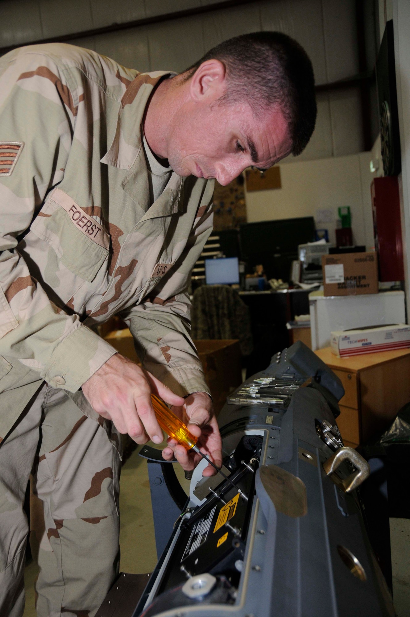 Staff Sgt. Jonathan Foerst checks the serviceability of the circuit card of a sniper pod Aug. 5 in an undisclosed location in Southwest Asia. Sergeant Foerst is a communication navigation mission system craftsman assigned to the 379th Expeditionary Aircraft Maintenance Squadron. (U.S. Air Force photo/Staff Sgt. Darnell T. Cannady) 
