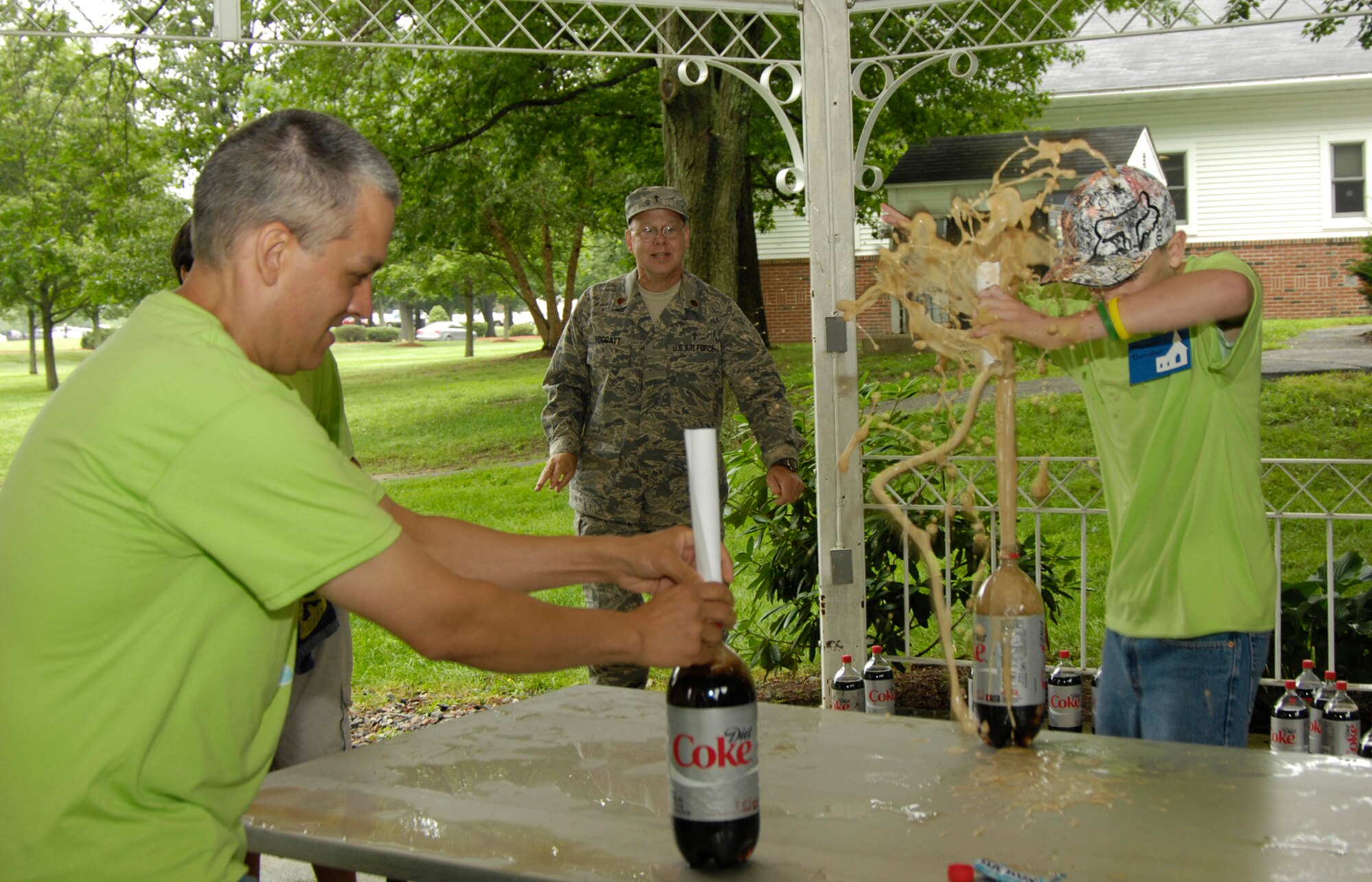 HANSCOM AFB, Mass. – Glen Manas (left), Chaplain (Maj.) William Hoggatt (center), and Thomas Donahue (right) perform a science experiment for participants in the chapel’s Vacation Bible School on Aug. 7. Vacation Bible School took place from Aug. 4 to 8; participants had the opportunity to take part in a number of religious educational programs, crafts and activities. (U.S. Air Force photo by Linda LaBonte Britt)


