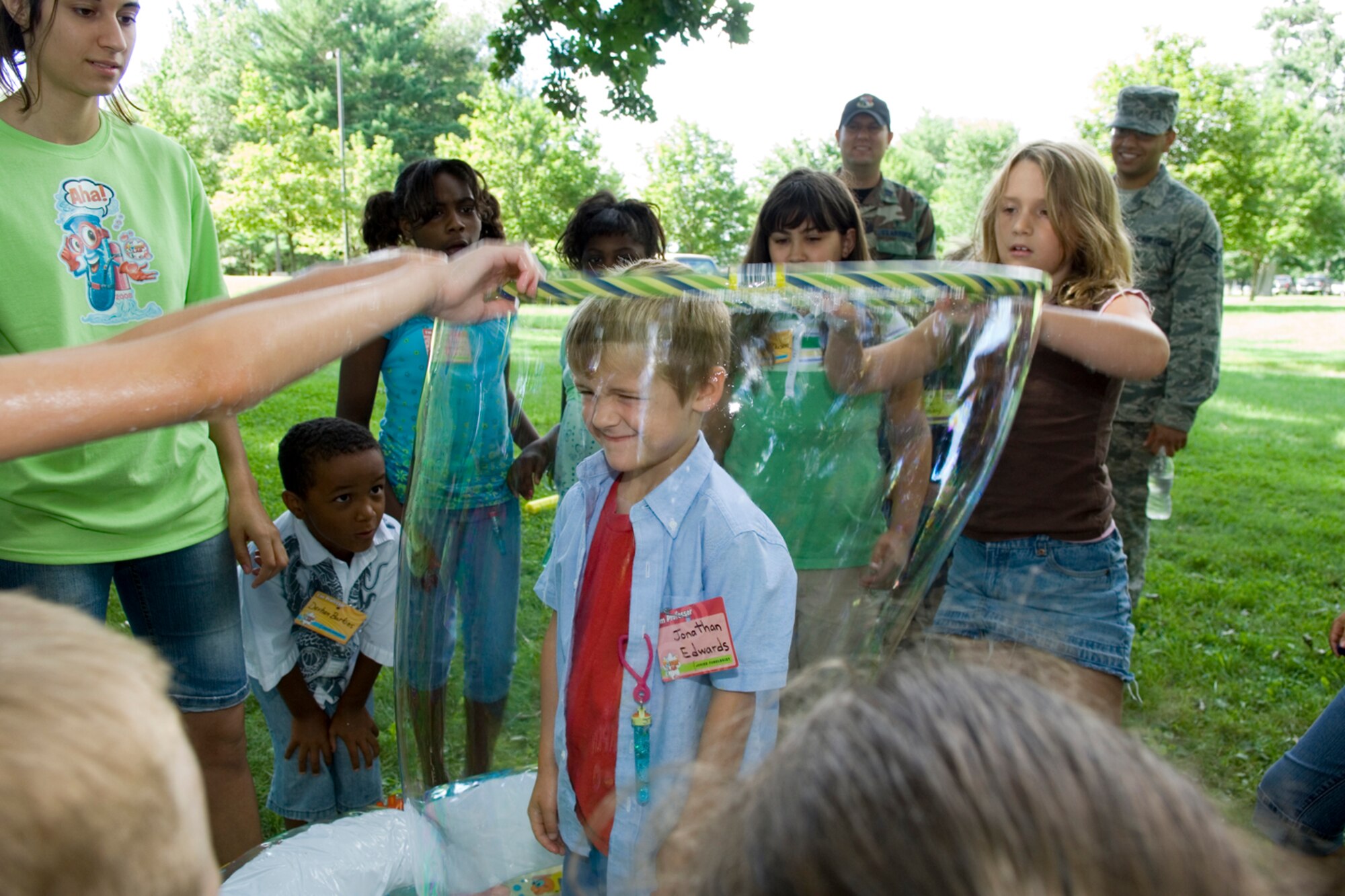 HANSCOM AFB, Mass. – Jonathan Edwards is surrounded with a bubble during a Vacation Bible School activity on Aug. 4 at the Base Chapel. The Base Chapel sponsored the Vacation Bible School from Aug. 4 to 8, approximately 140 children participated and 59 adults volunteered to help with the week-long activities. (U.S. Air Force photo by Rick Berry)