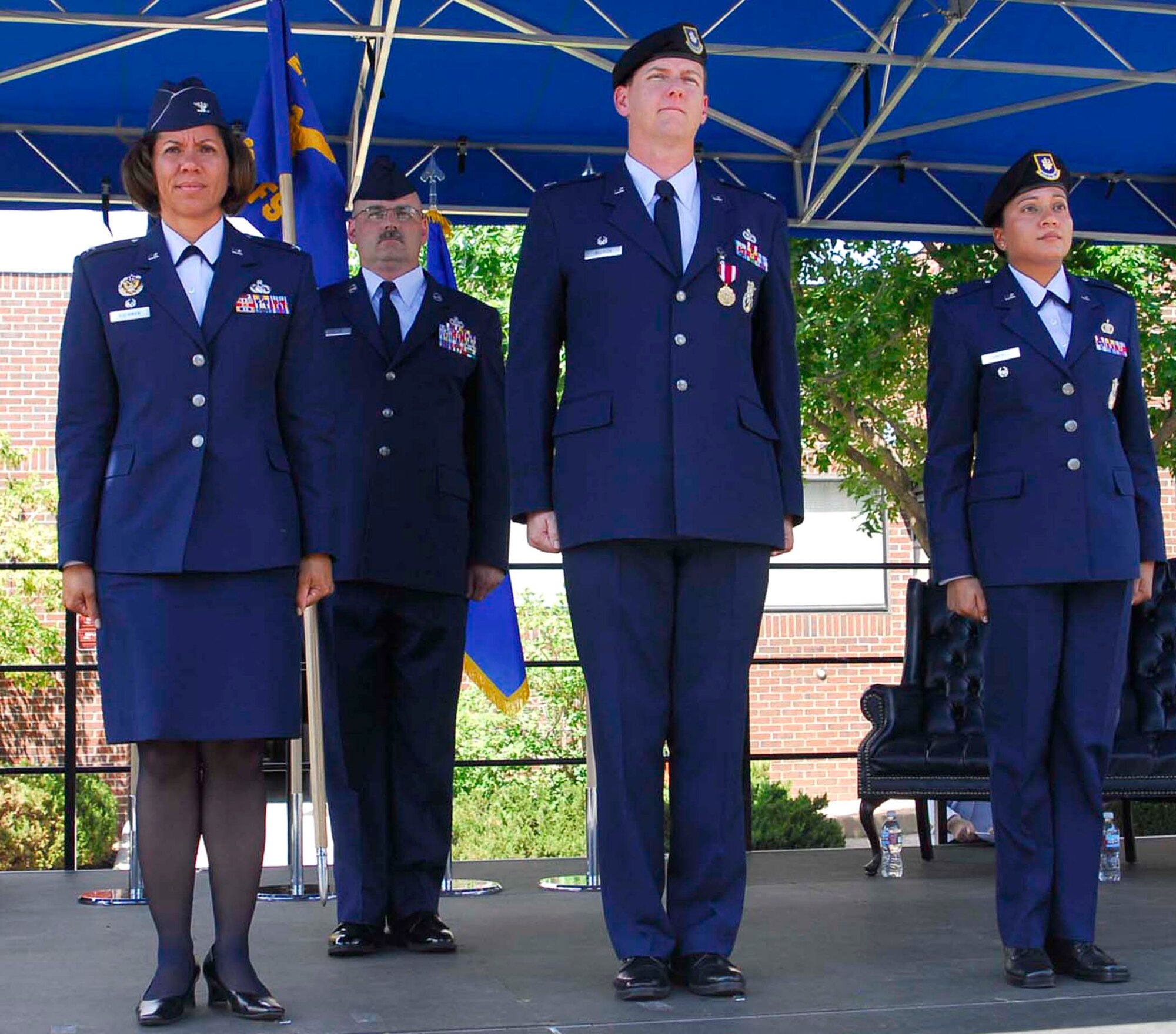 Maj. Renee Campbell (far right) assumed command of the 21st Security Forces Squadron from Lt. Col. Thomas Allison (middle) in a ceremony Aug. 1 at Peterson Air Force Base, Colo. Maj. Campbell joins the ‘Knights’ of the 21st Space Wing from Al Udeid Air Base, Qatar, where she was chief of the resources and training division, Force Protection Directorate. Some of the major’s accomplishments while assigned to Al Udeid AB include the acquisition of 231 Mine Resistant Ambush Protected vehicles valued at more than $135 million and ensured distribution of the vehicles to Air Force Central units. Her efforts also saved Airmen’s lives across the theater, ensuring protection from lethal improvised explosive devices. The 21st SFS’ outgoing commander, Lieutenant Colonel Allison, is moving on to Headquarters Air Force Space Command Security Forces Directorate. The ceremony was officiated by Col. Emily Buckman (left), 21st Mission Support Group commander. (U.S. Air Force photo/Rob Lingley)