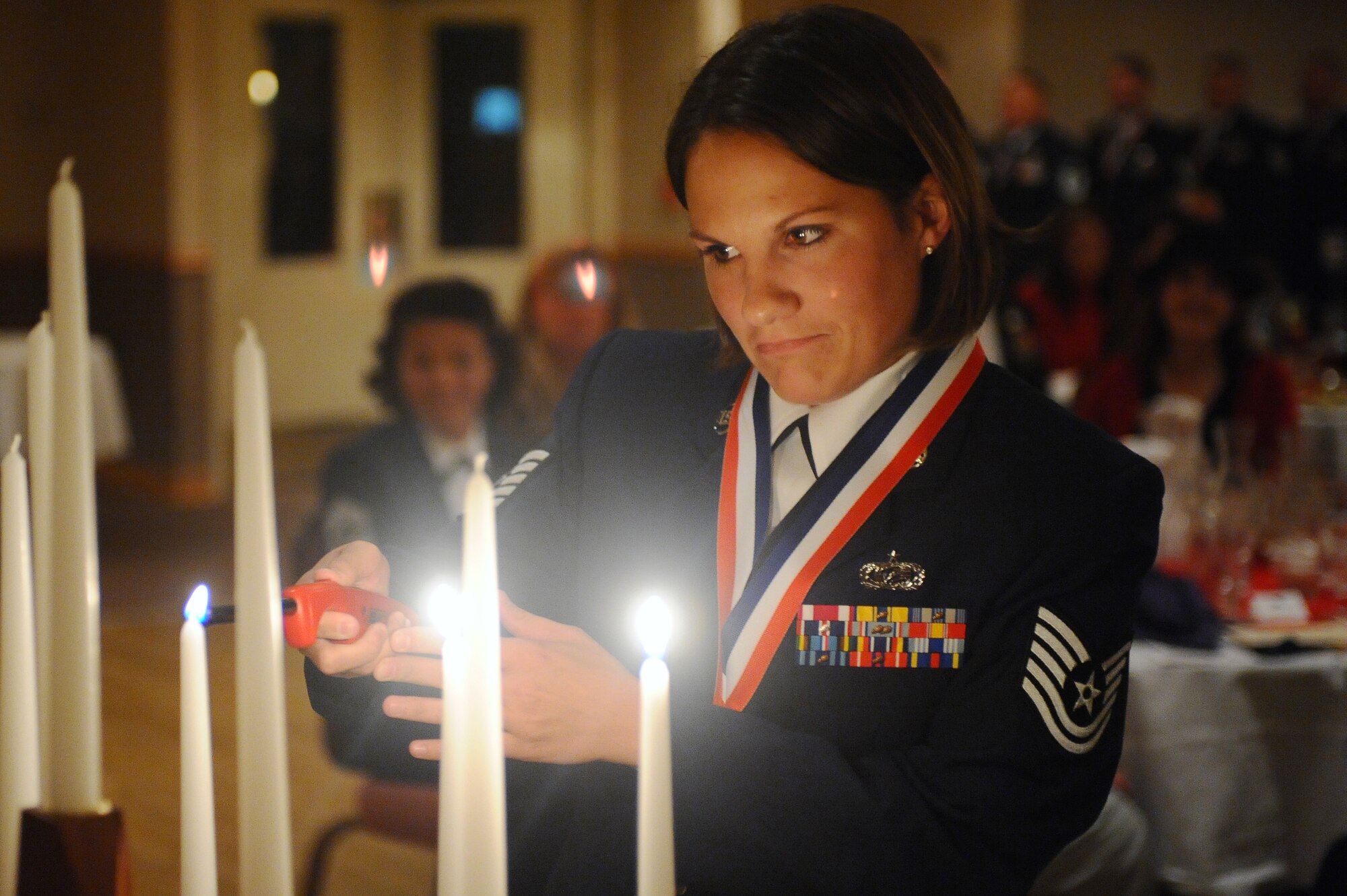 Tech. Sgt. Tamara Knause lights the third candle in this enlisted time honored tradition Aug. 1, 2008, at Eielson Air Force Base, Alaska. The Senior Non-Commissioned Officers induction ceremony is held to recognize individuals who progress through the ranks and have been selected for master sergeant promotion transitioning them to senior leadership level with more responsibility. (U.S. Air Force photo by Airman 1st Class Jonathan Snyder)