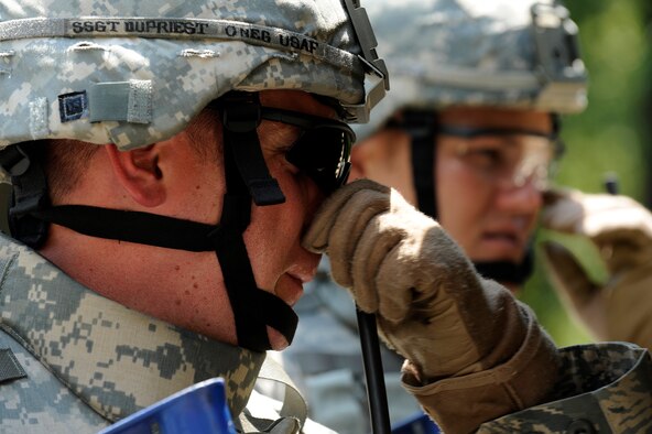 MOODY AIR FORCE BASE, Ga. -- Staff Sgts. Jeremiah Dupriest and Gary Hilliard, both 823rd Security Forces Squadron, watch a monitor screen that shows what a wheeled robot is looking at here July 25. The 823rd SFS members used a test phase wheeled robot during improvised explosive device sweep training. (U.S. Air Force photo by Airman 1st Class Brittany Barker) 
