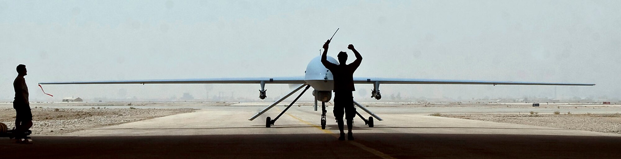 An MQ-1B Predator aircraft taxies into a hangar here after a mission Aug. 1. A $1 headset modification made by Staff Sgt. Ray Stetler allows Predator pilots to use Voice Over Secure Internet Protocol communications through their headsets. Sergeant Stetler is the NCO in charge of base information and infrastructure for the 407th Expeditionary Communications Squadron at Ali Base, Iraq. (U.S. Air Force photo/Airman 1st Class Christopher Griffin)