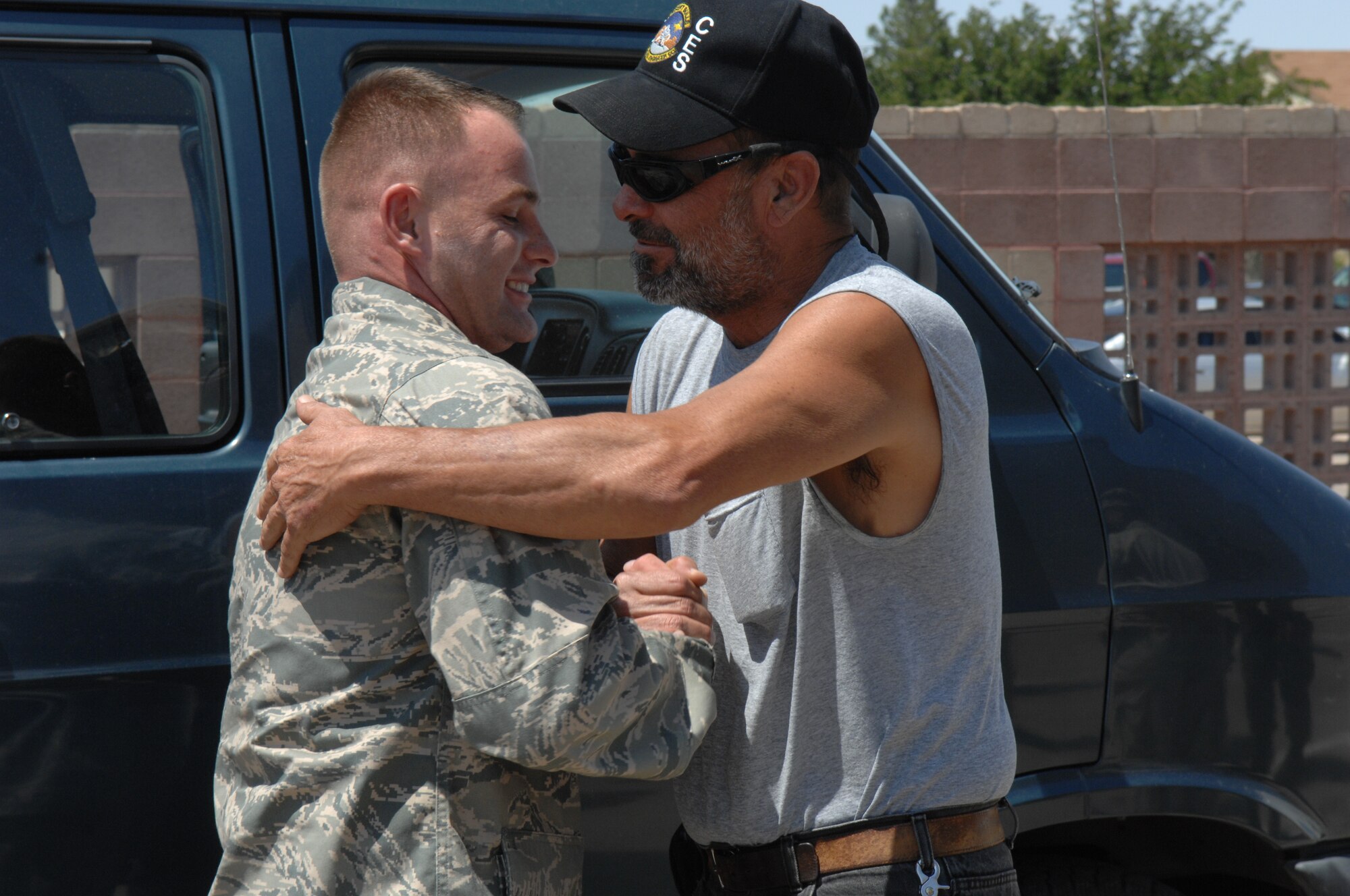 Tech. Sgt. Shaun Goodenow, 49th Civil Engineer Squadron, is greeted by a co-worker Aug. 6 at Holloman Air Force Base, N.M., after returning home from a four month deployment. While deployed, the team moved 700,000 feet of rubber to six locations in three different countries to include Iraq and Afghanistan. (U.S. Air Force photo/Senior Airman Anthony Nelson Jr)