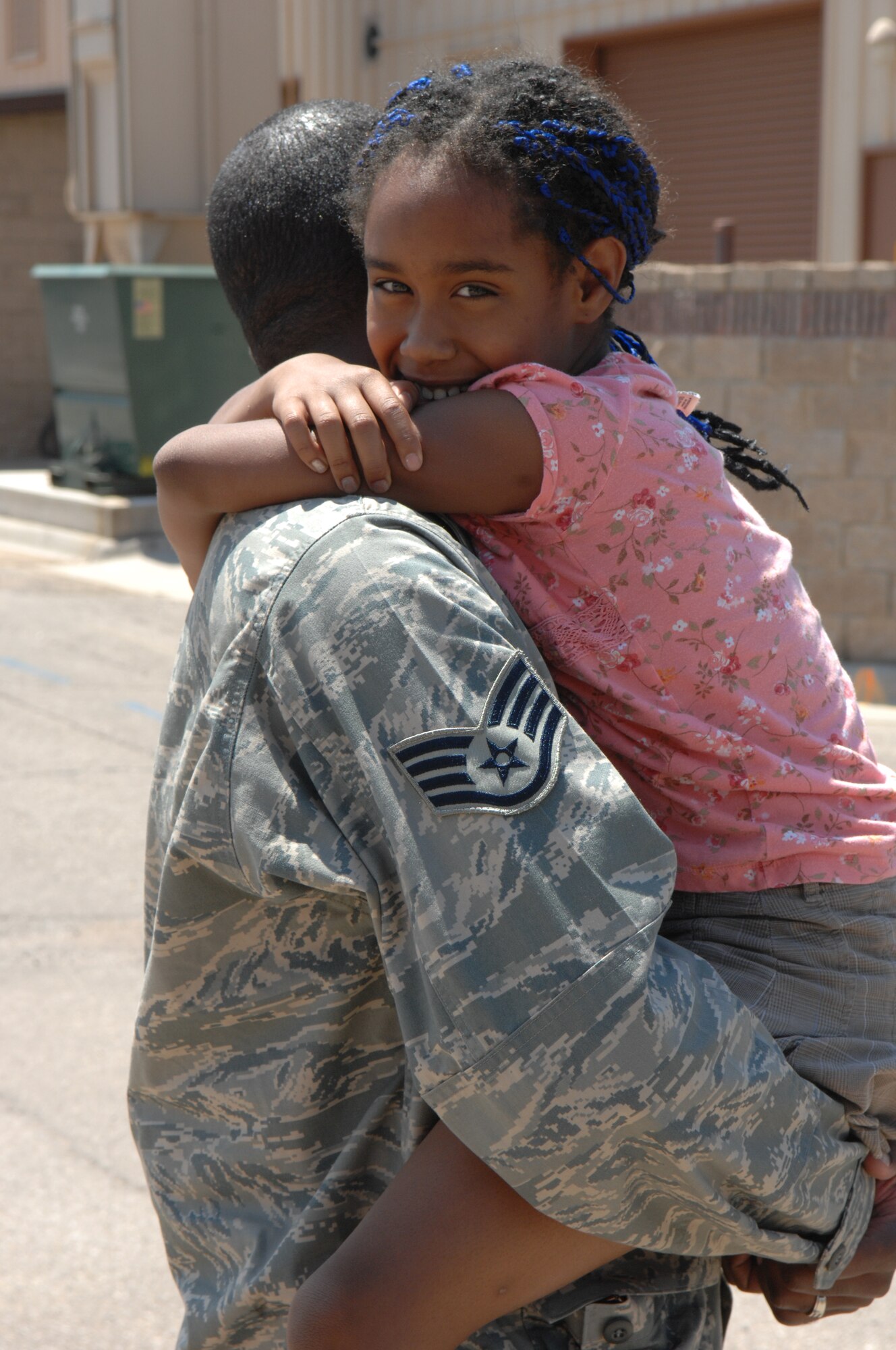Staff Sgt. Kevin Dysart, 49th Civil  Engineer Squadron, hugs his daughter Aug. 6 at Holloman Air Force Base, N.M., after returning home from a four month deployment. While deployed, the team moved 700,000 feet of rubber to six locations in three different countries to include Iraq and Afghanistan. (U.S. Air Force photo/Senior Airman Anthony Nelson Jr)