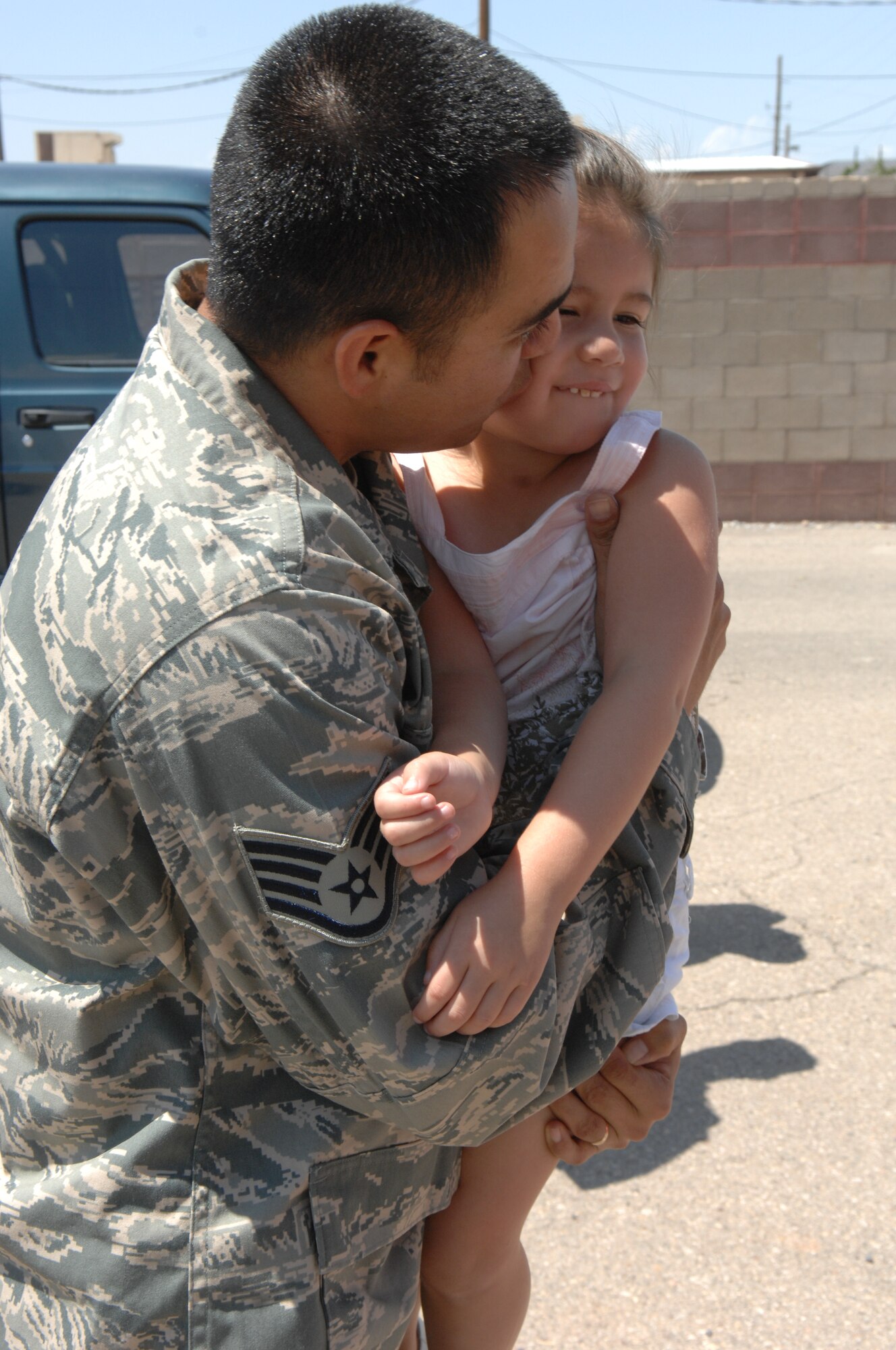 Staff Sgt. Jason Cordero, 49th Civil Engineer Squadron, hugs his daughter Aug. 6 at Holloman Air Force Base, N.M. Sergeant Cordero was deployed with three other Airmen from the 49th CES. While deployed, the team moved 700,000 feet of rubber to six locations in three different countries to include Iraq and Afghanistan. (U.S. Air Force photo/Senior Airman Anthony Nelson Jr)


